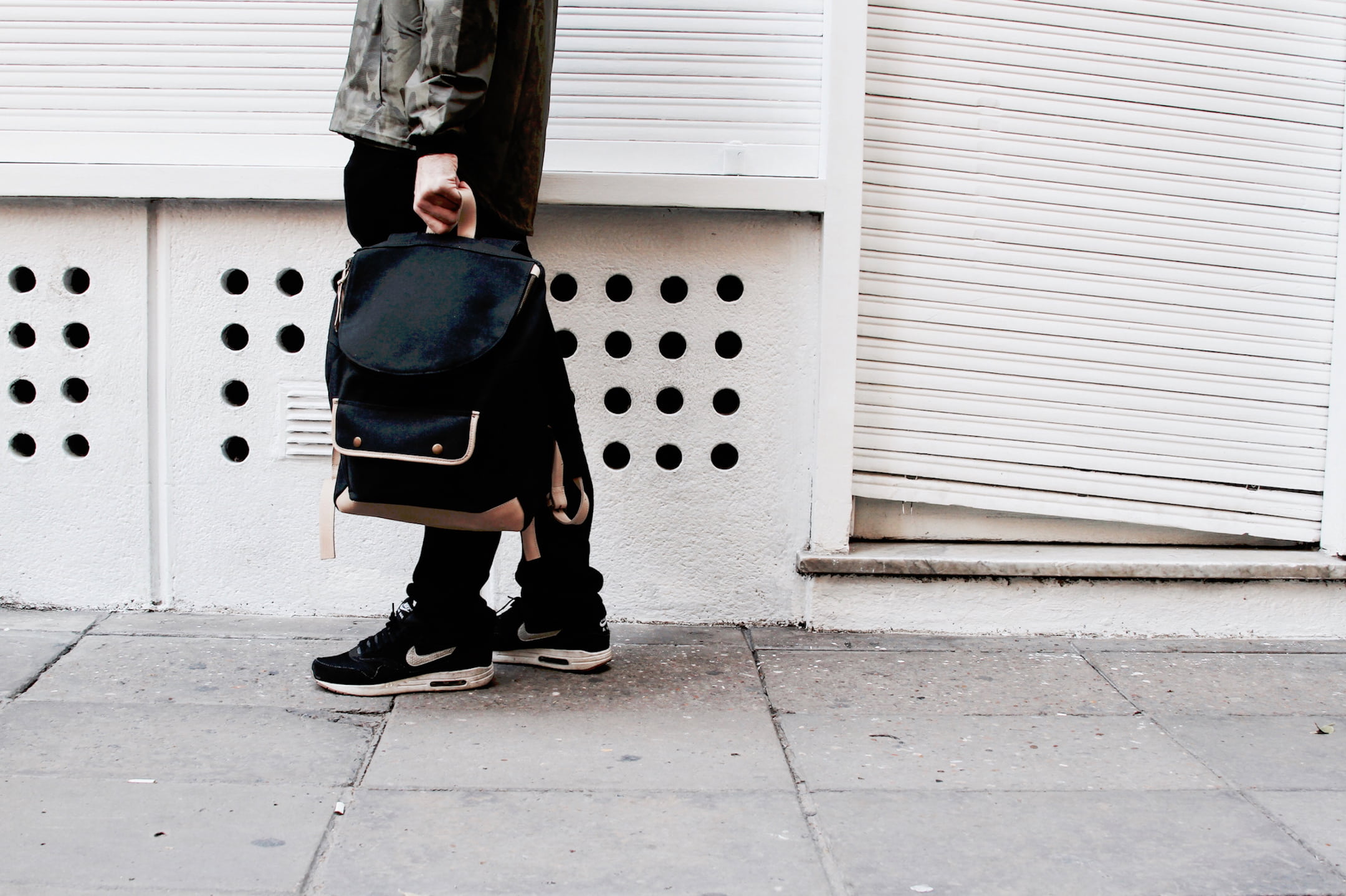 wall, black, jacket, iron, architecture, man, people, built structure, bag, holding, nike, 1080P, guy, outdoors, wall - building feature, real people, HD Wallpaper