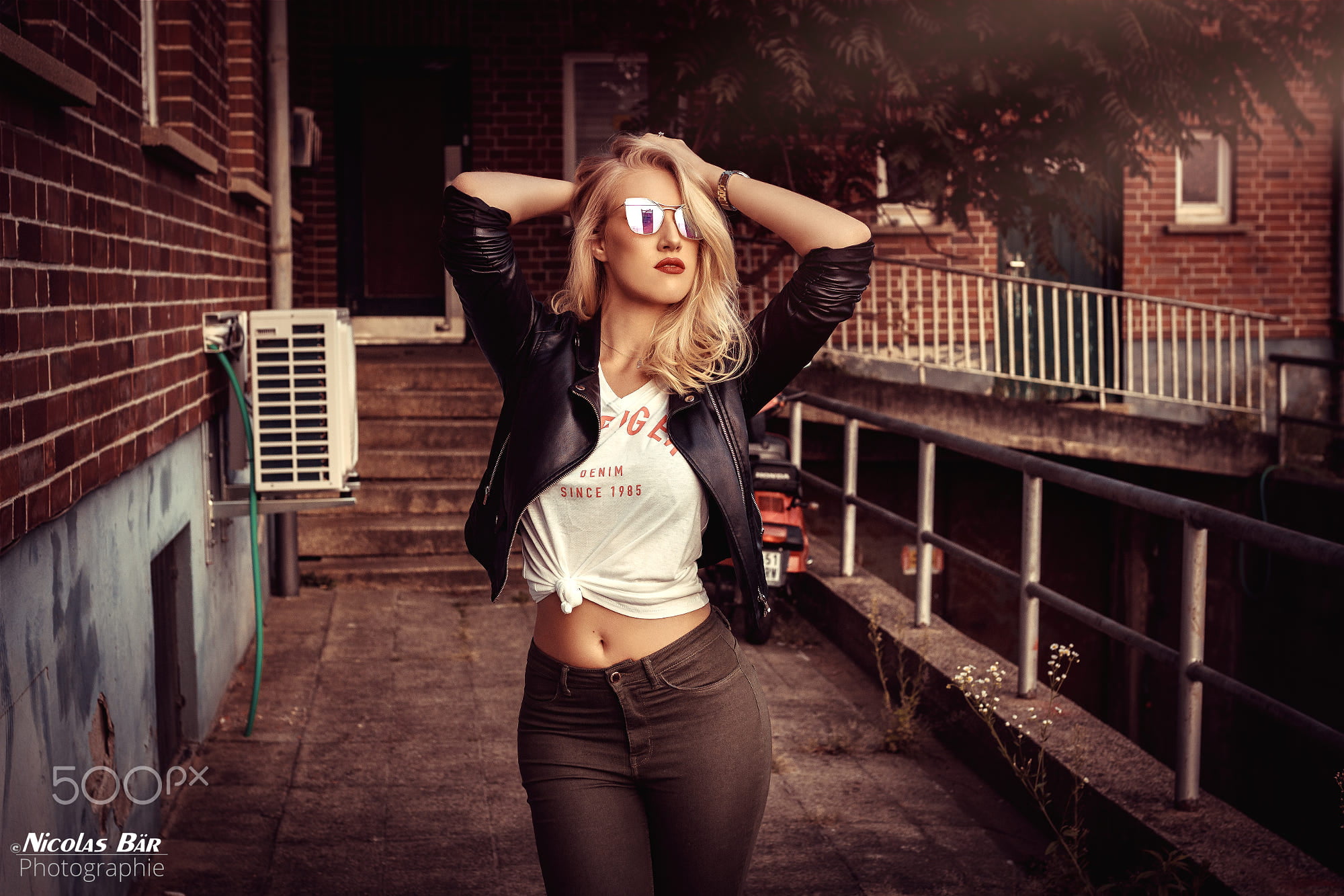 red lipstick, front view, hairstyle, blonde, three quarter length, beauty, architecture, lifestyles, hands in hair, leather jackets, jeans, arms raised, HD Wallpaper