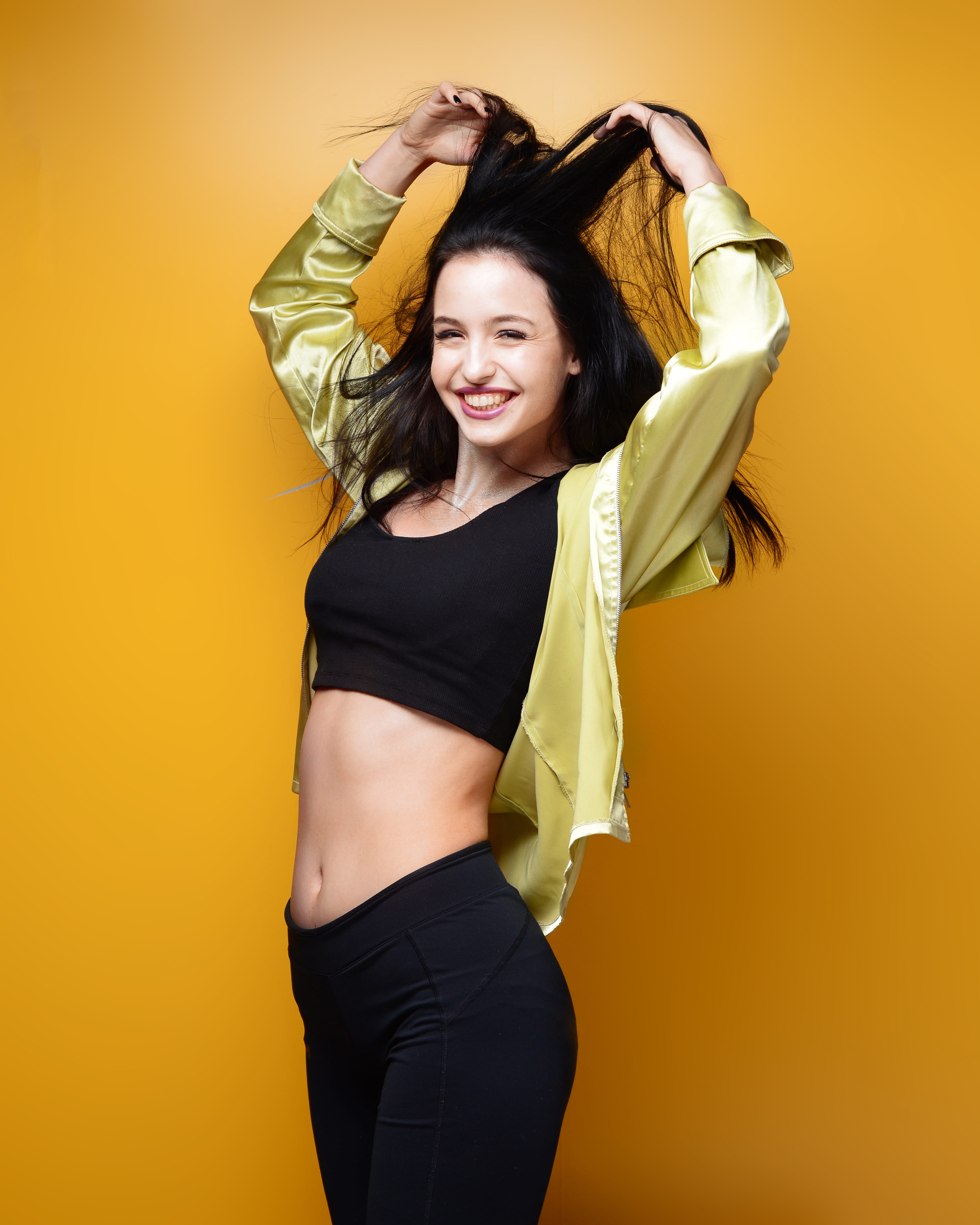 holding, studio shot, active wear, yellow background, brunette, young adult, posing, wear, three quarter length, standing, happiness, facial expression, Phone HD Wallpaper