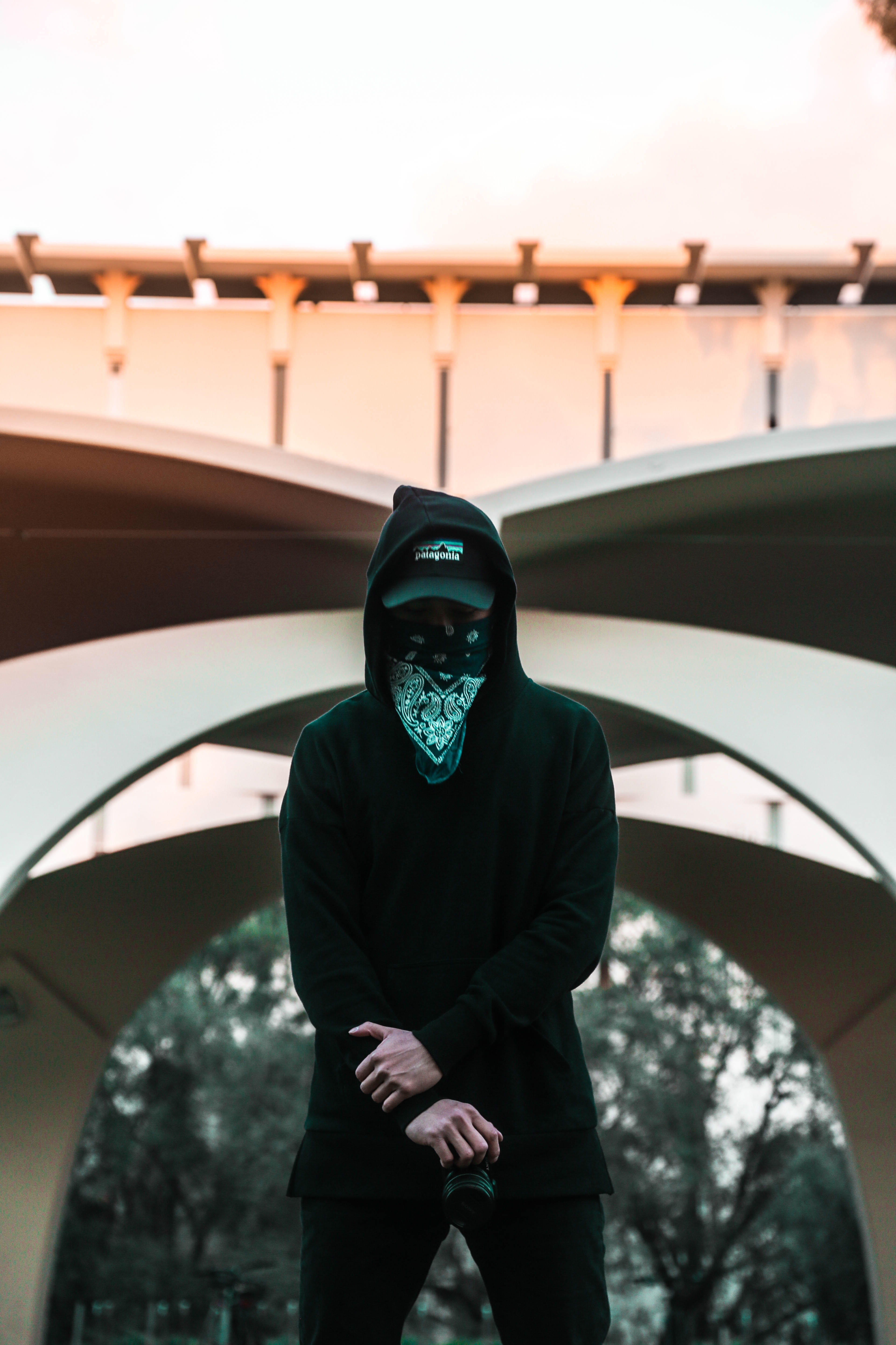 man, looking at camera, front view, outdoors, hoodie, mask - disguise, lifestyles, one person, symmetry, street, portrait, three quarter length, building, Phone HD Wallpaper