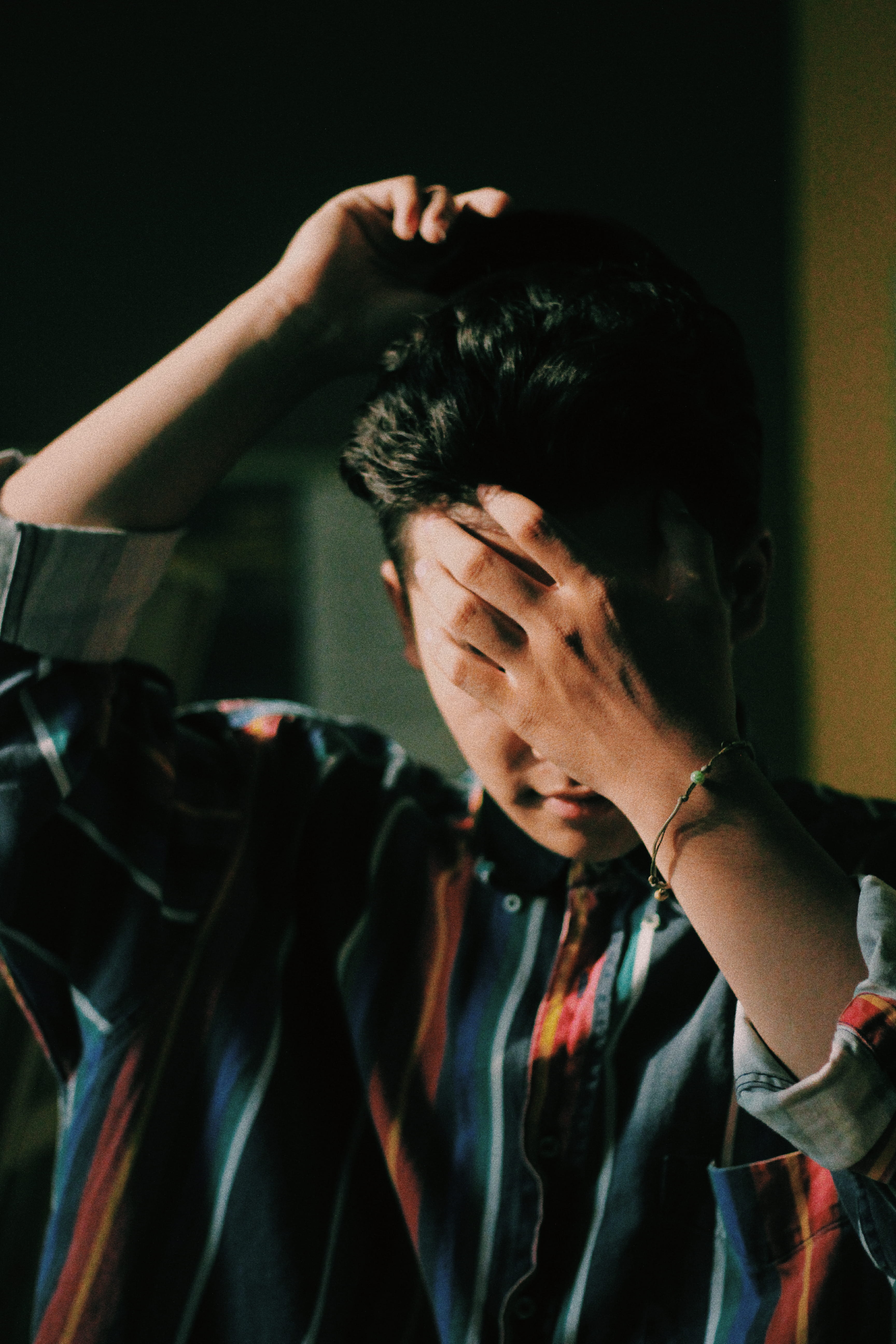 boy, sadness, indoors, arms raised, headshot, 5K, young adult, front view, emotional stress, one person, looking, head in hands, stripy shirt, hand in hair, Phone HD Wallpaper