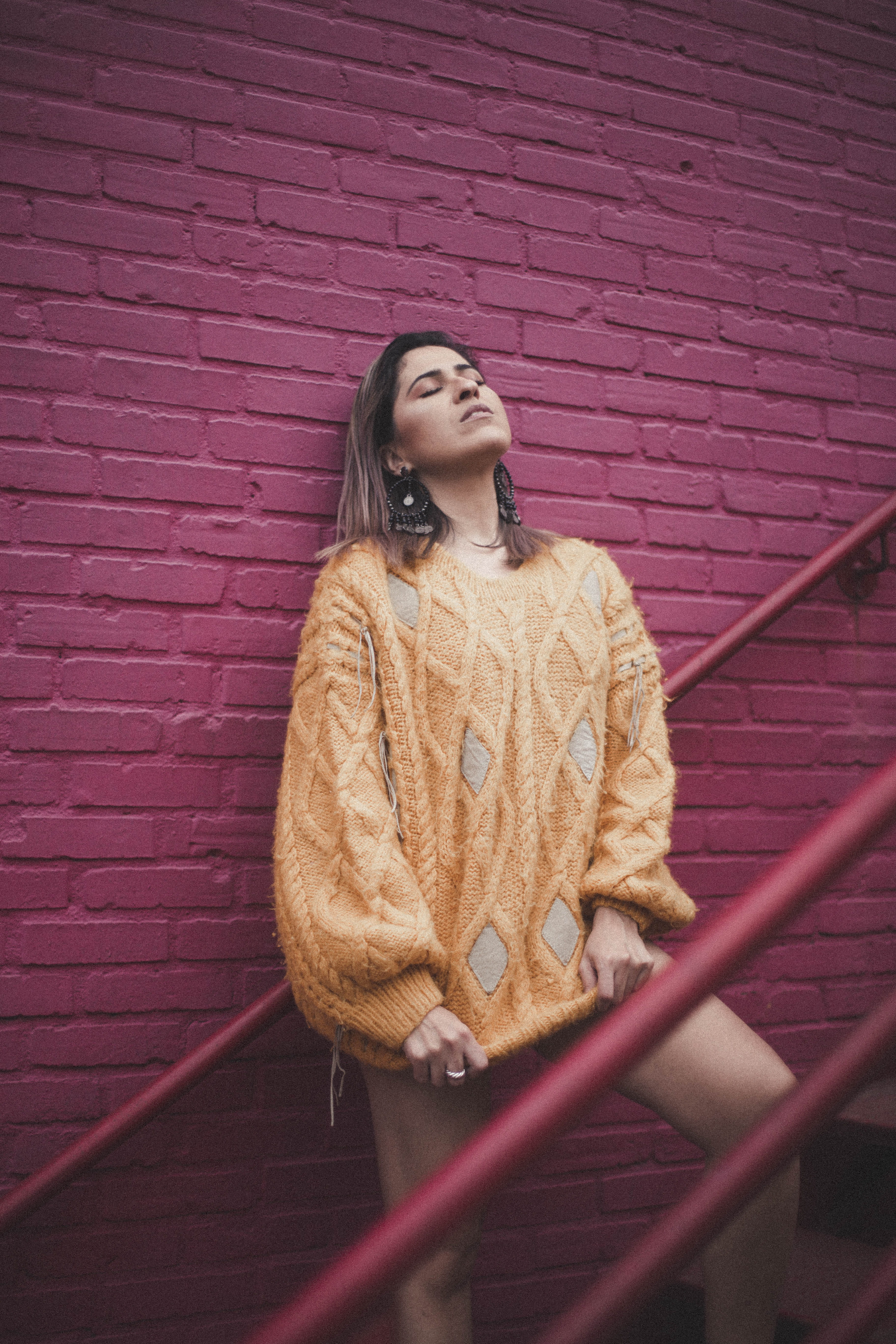warm clothing, sweater, built structure, clothing, three quarter length, 5K, architecture, fashion, brick wall, wall - building feature, colors, hair, Phone HD Wallpaper
