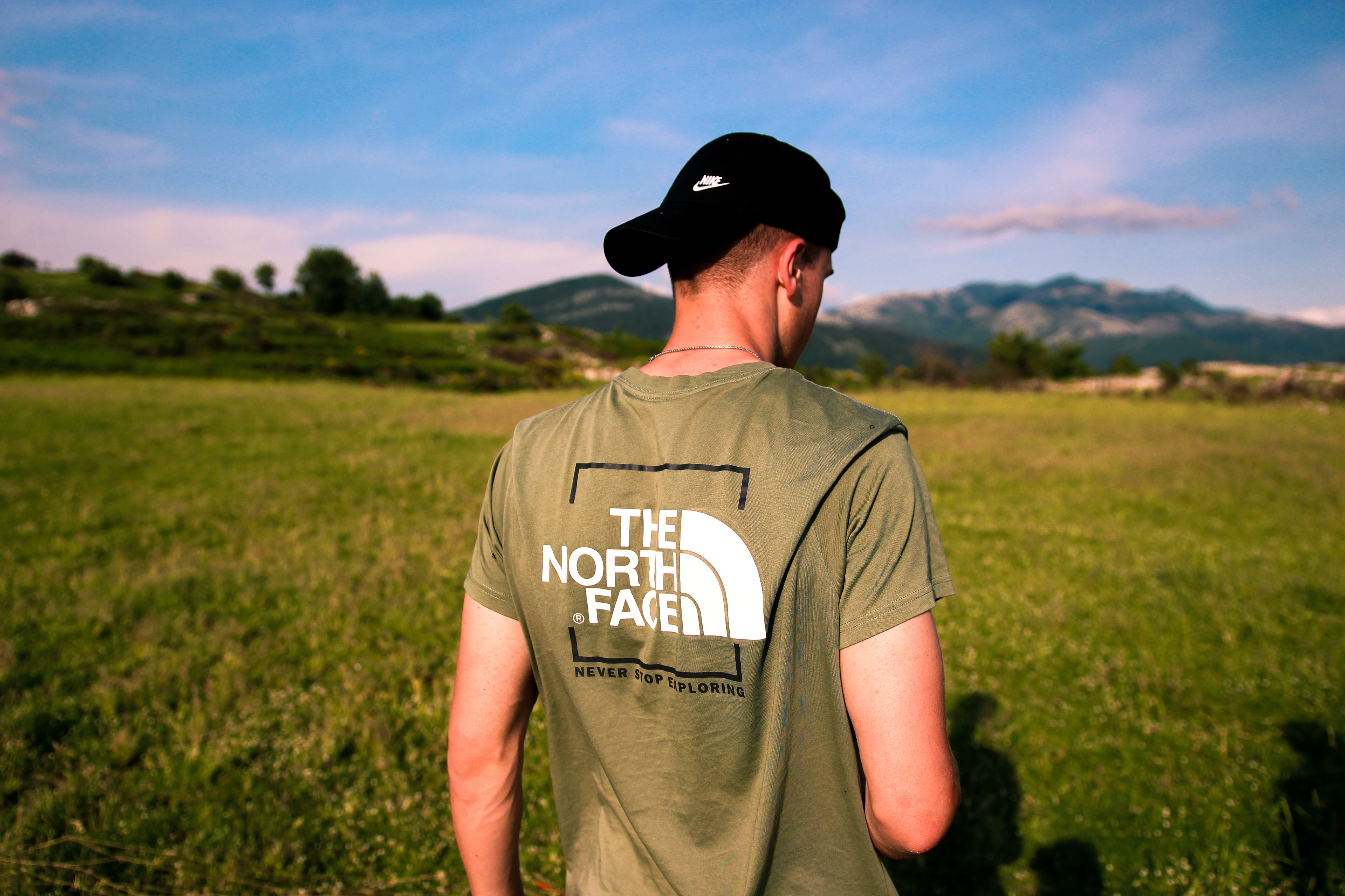the noth face, t-shirt, cap, rom, apparel, western script, face, uniform, summer, brown, plant, one person, occupation, human, government, land, photo, HD Wallpaper