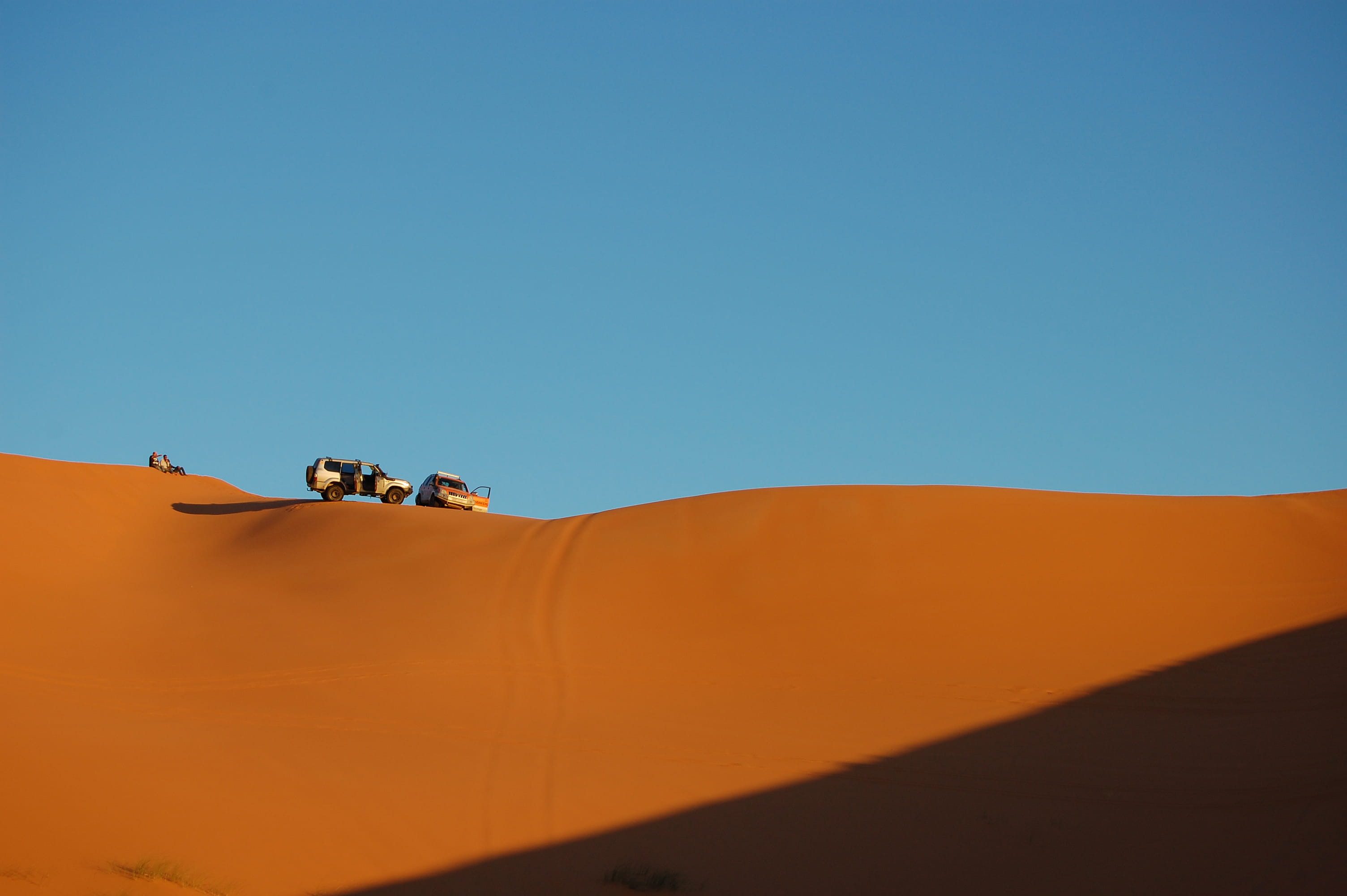 travel, desert, extreme Sports, day, one Person, explore, vehicle, shadow, top, contrast, car, sky, sunlight, 2K, sport, orange Color, sahara Desert, men, HD Wallpaper