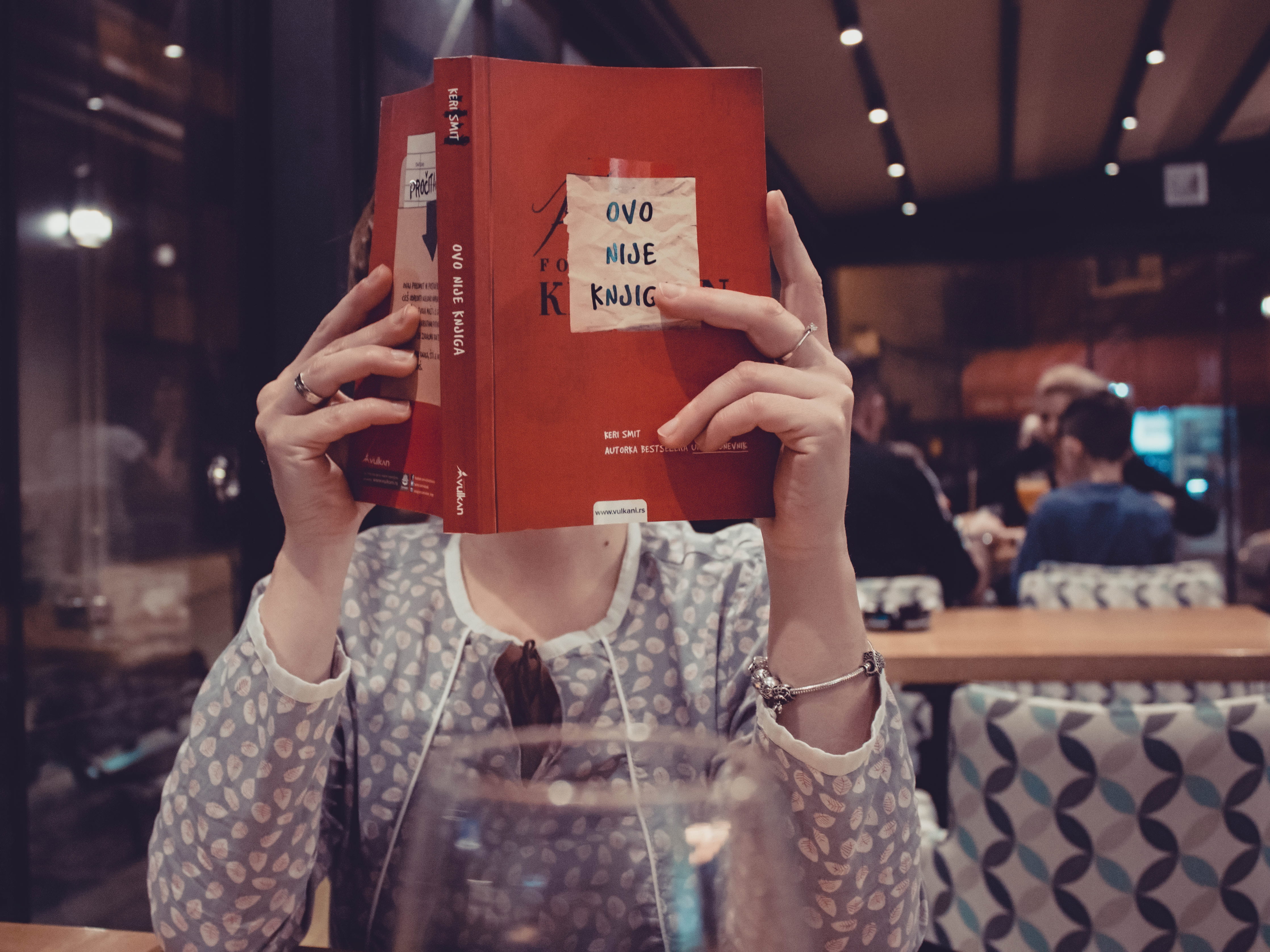casual clothing, journal, adult, real people, book, front view, women, indoors, obscured face, incidental people, holding, reading, table, focus on foreground, HD Wallpaper