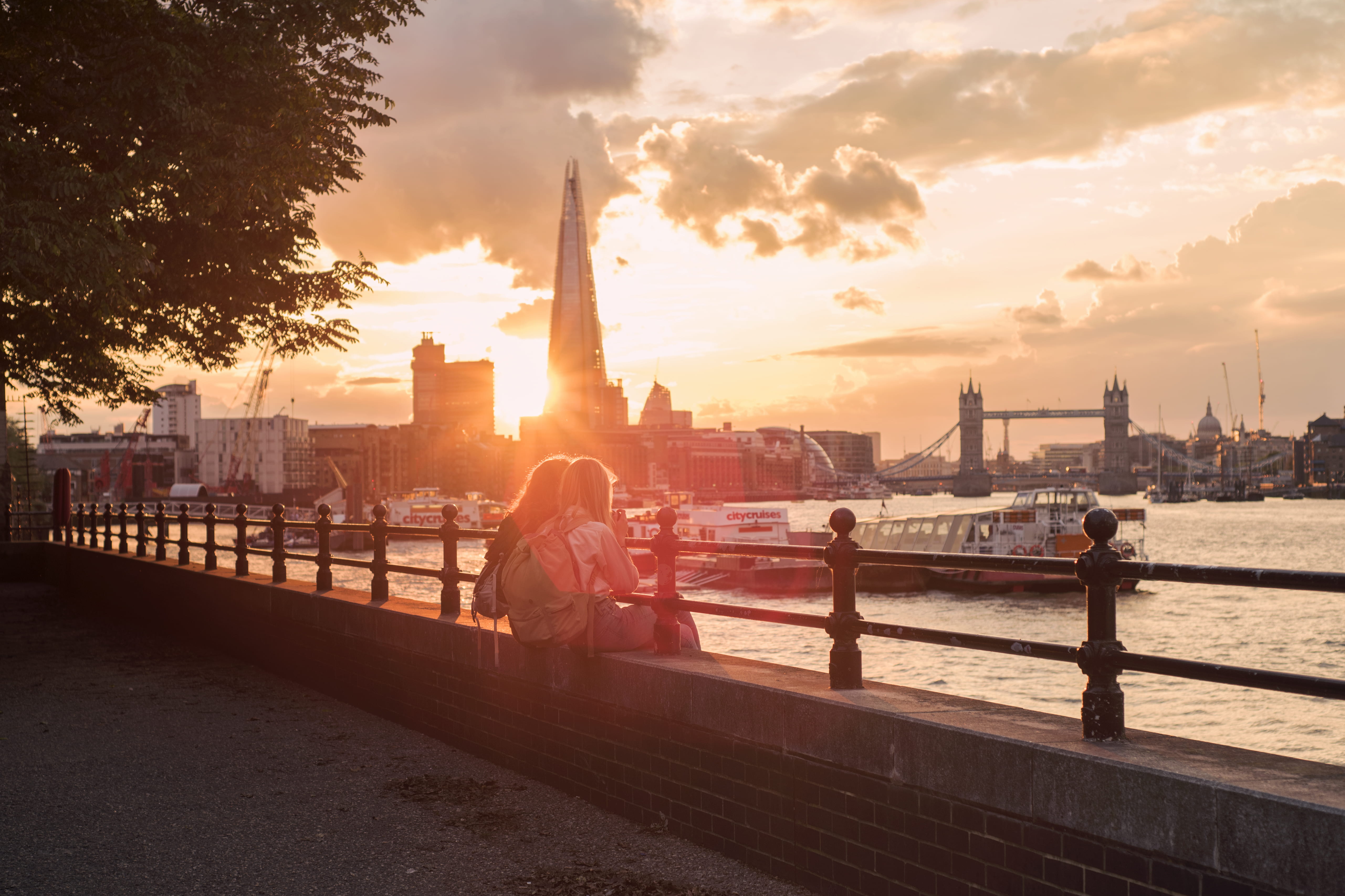 women, city, person, the shard, concrete, sitting, sunlight, tower bridge, wall, railing, river thames, lens flare, water, building exterior, nature, real people, HD Wallpaper