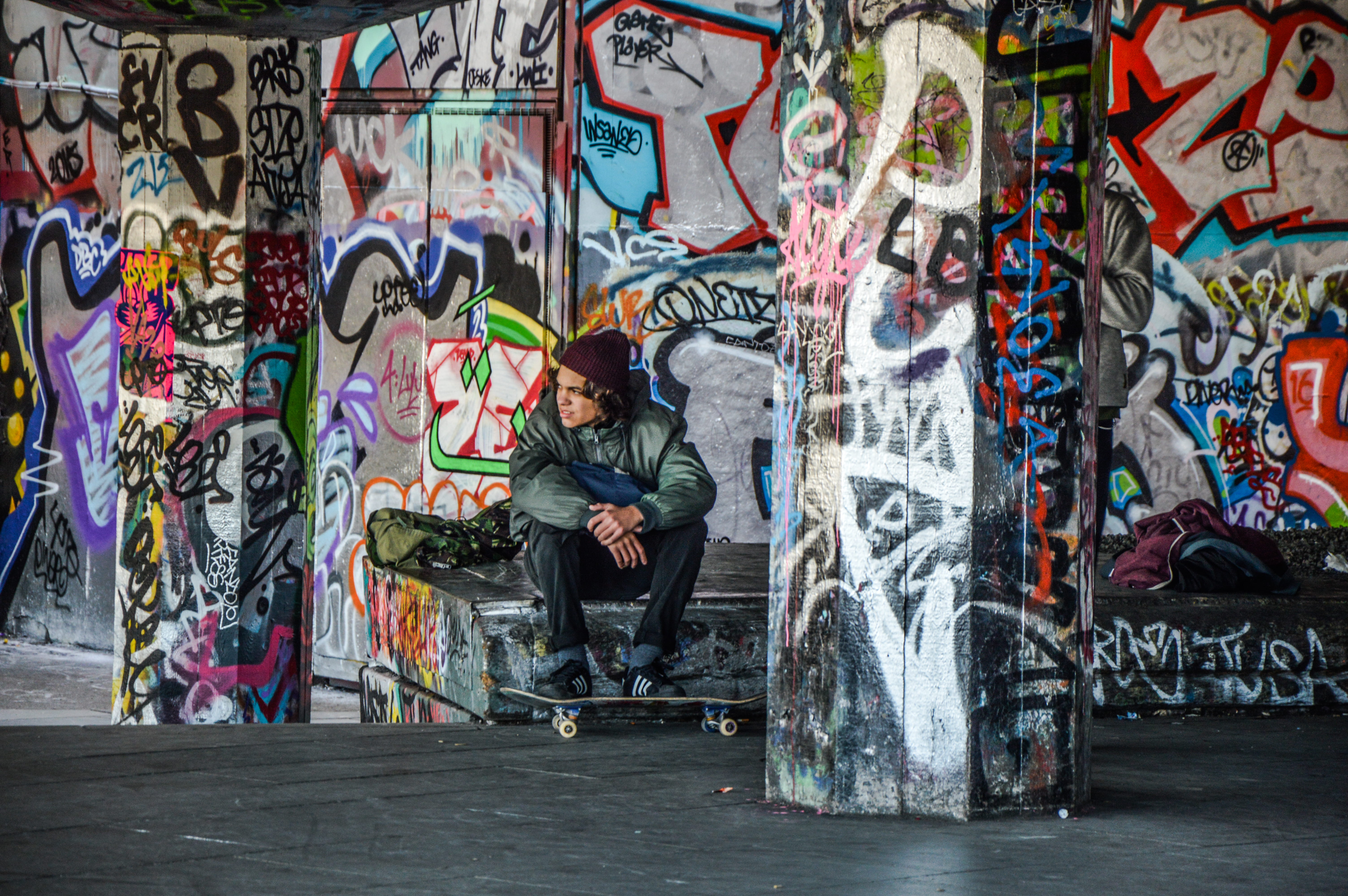 jacket, young adult, lifestyles, art and craft, bench, multi colored, creativity, guy, wearing, skateboard, london, hip hop, sitting, male, one person, HD Wallpaper