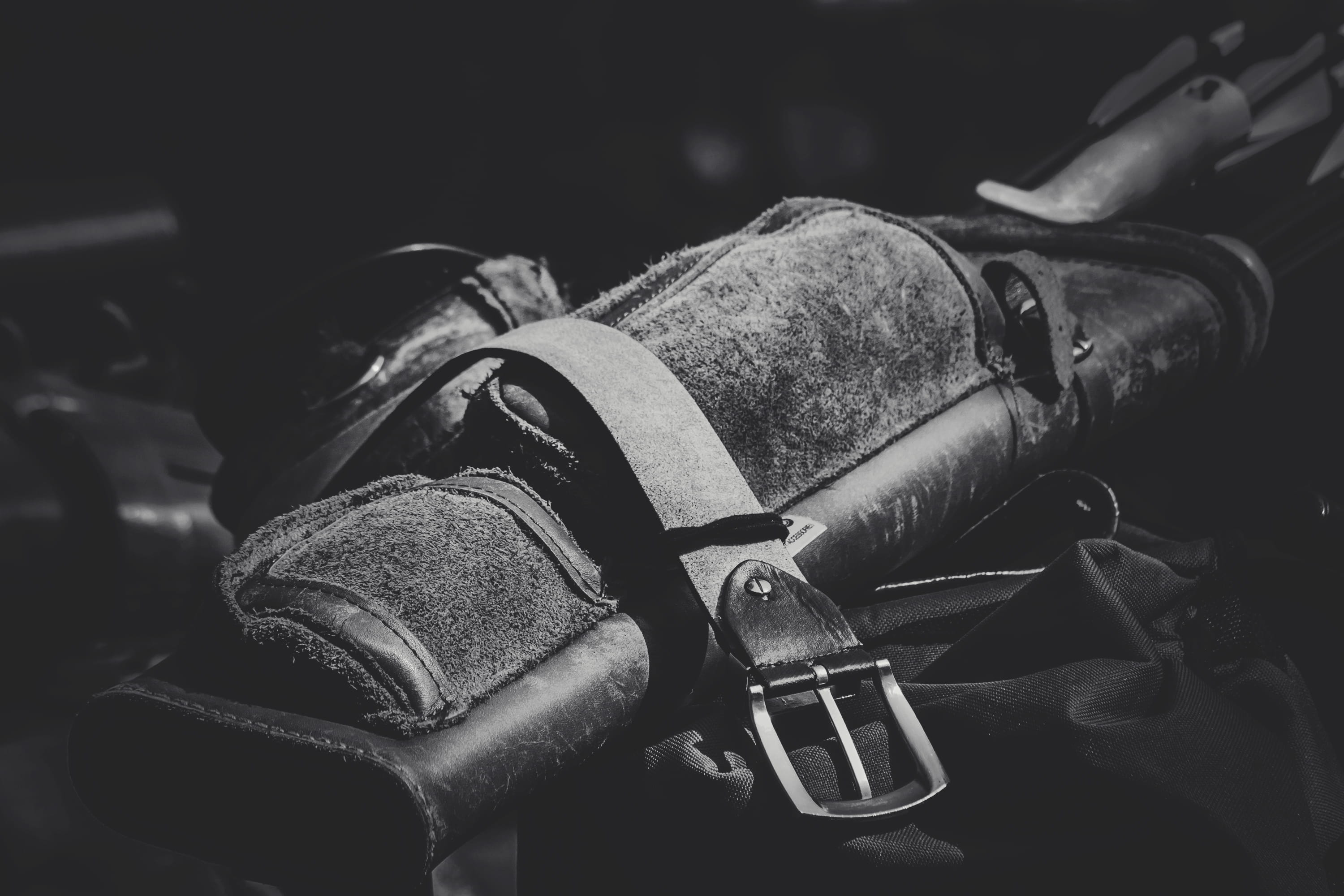 protection, focus on foreground, leather, black-and-white, metal, selective focus, buckle, weapon, gun, human body part, photo, holding, close-up, hand, HD Wallpaper