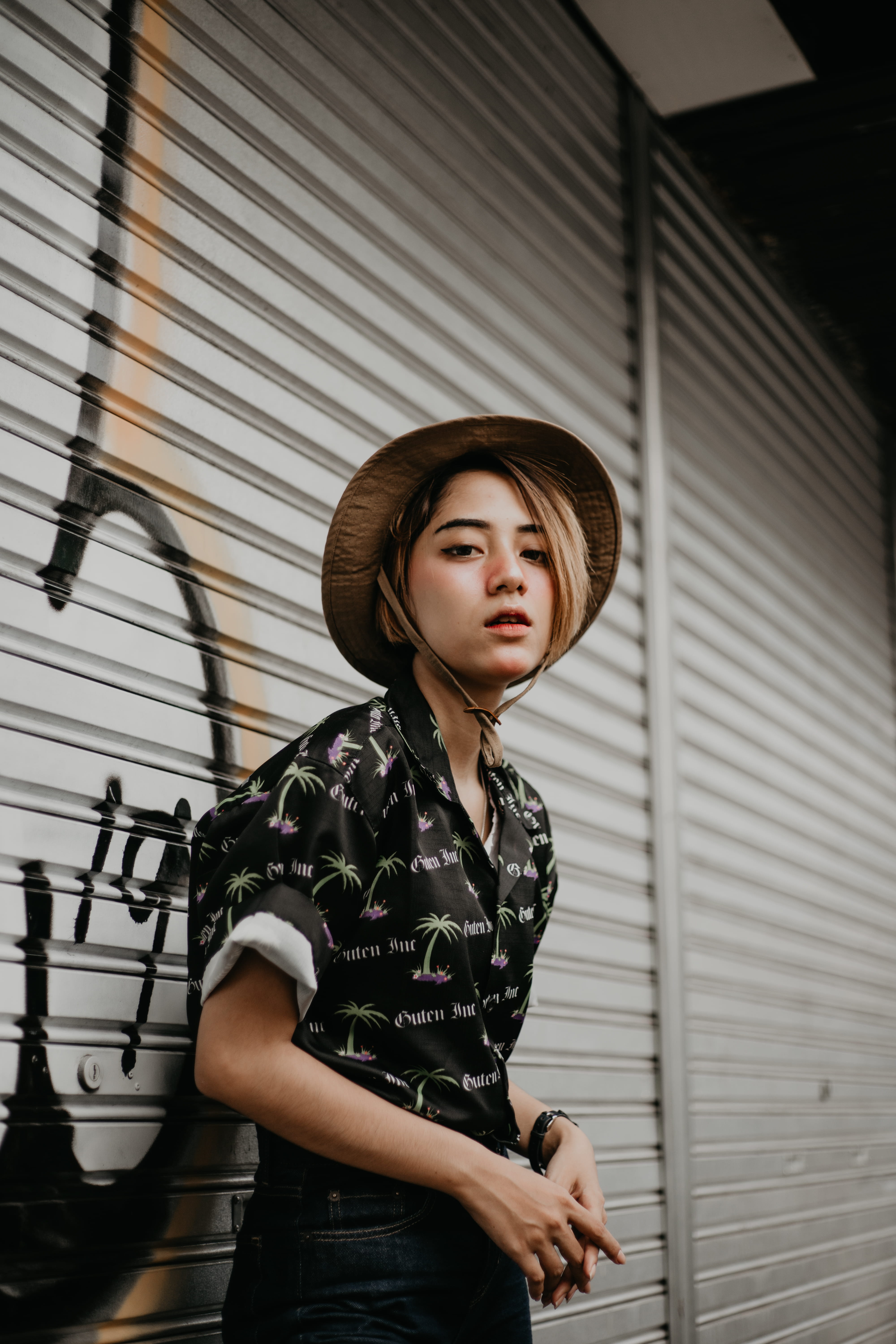musical instrument, hairstyle, 5K, built structure, contemplation, symbol, one person, real people, young adult, arrow, apparel, finger, long sleeve, wall - building feature, Phone HD Wallpaper