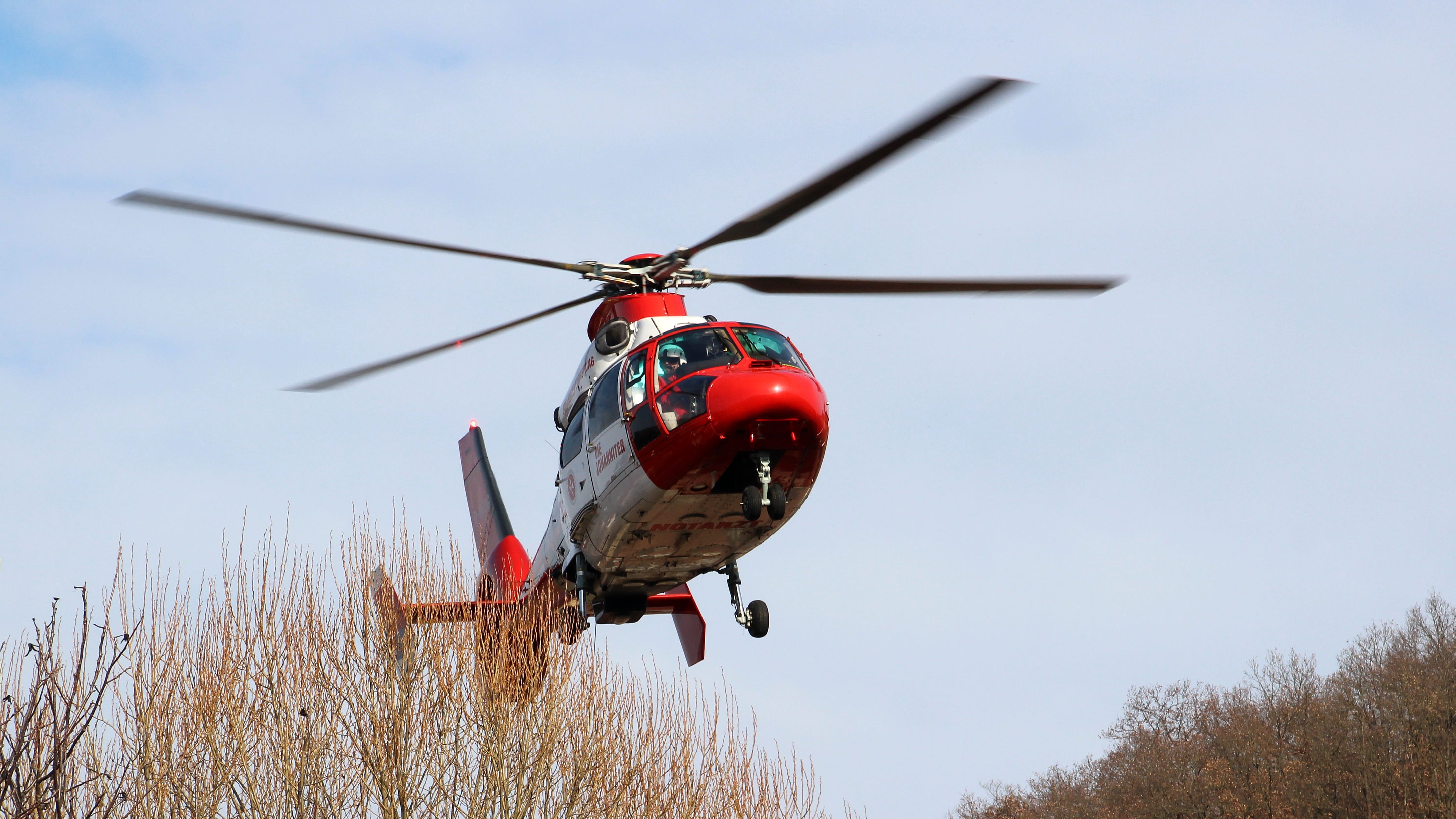 transportation, red, 4K, mode of transportation, air vehicle, motion, mid-air, ambulance service, tree, sky, aerospace industry, travel, nature, no people, HD Wallpaper