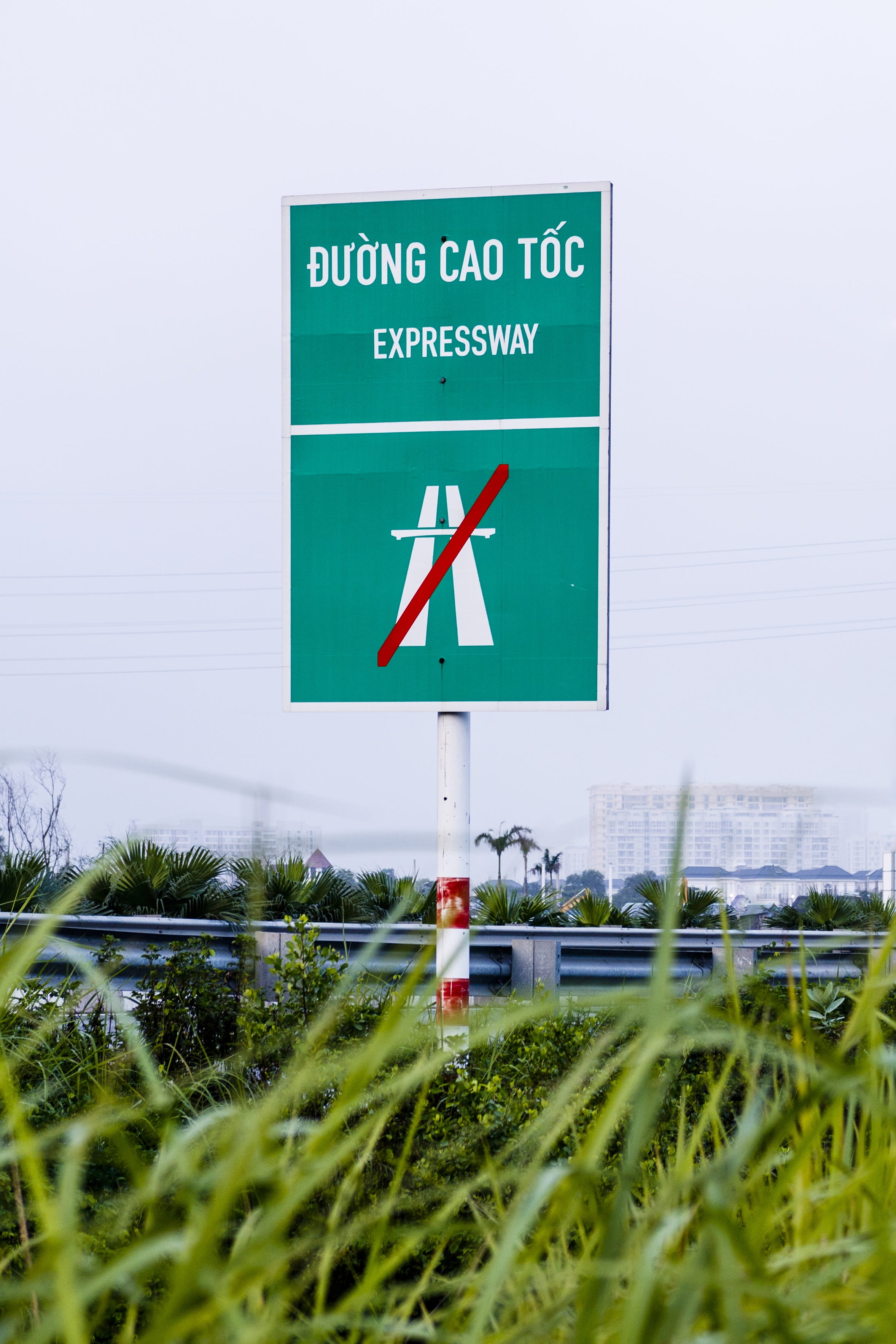 street, outdoors, 2K, communication, directional sign, sky, arrow symbol, express, day, transportation, guidance, text, information, grass, information sign, Phone HD Wallpaper