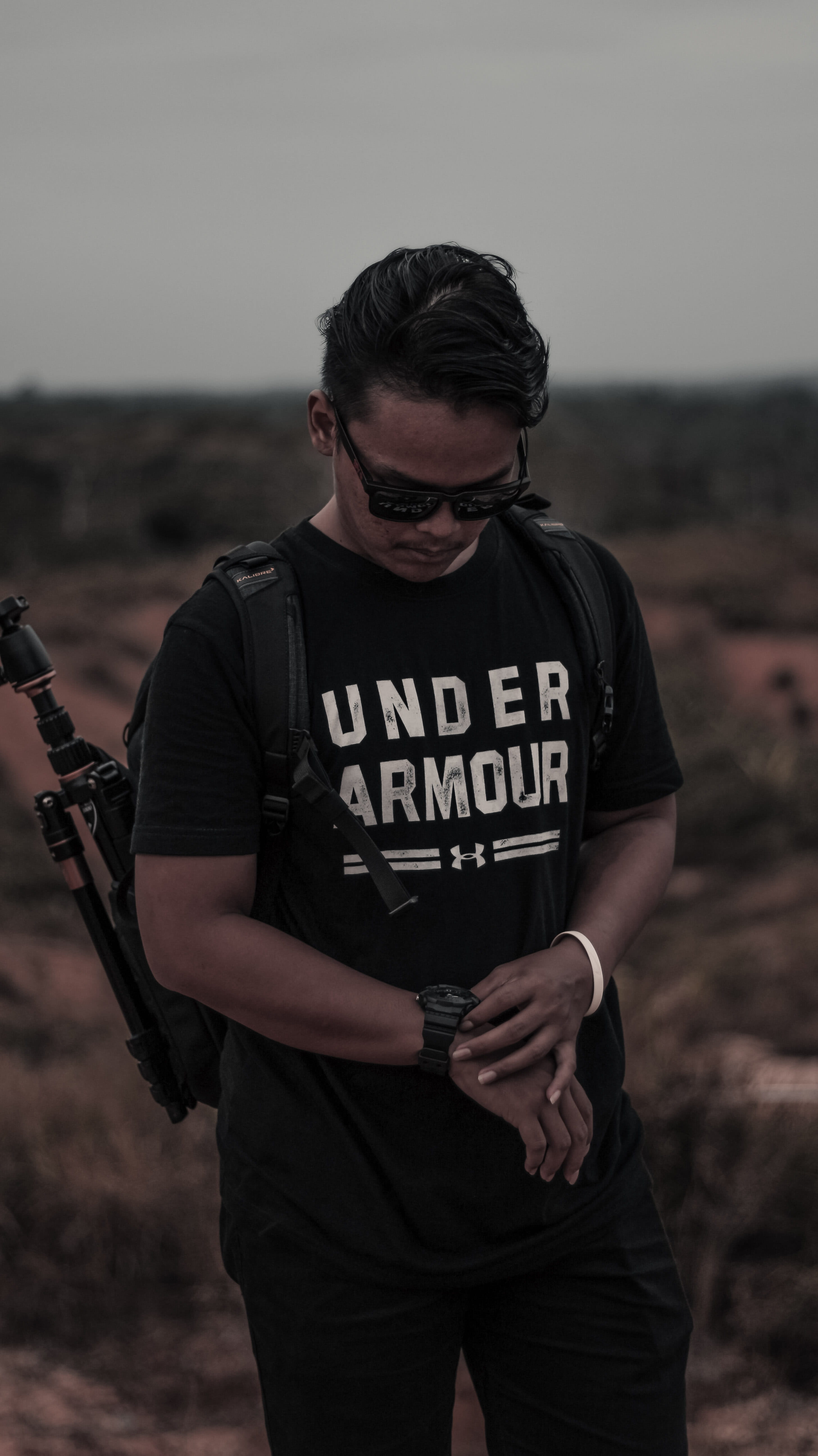 standing, young adult, black, holding, shirt, focus on foreground, tripod, person, casual clothing, nature, armour, man, communication, one person, leisure activity, Phone HD Wallpaper