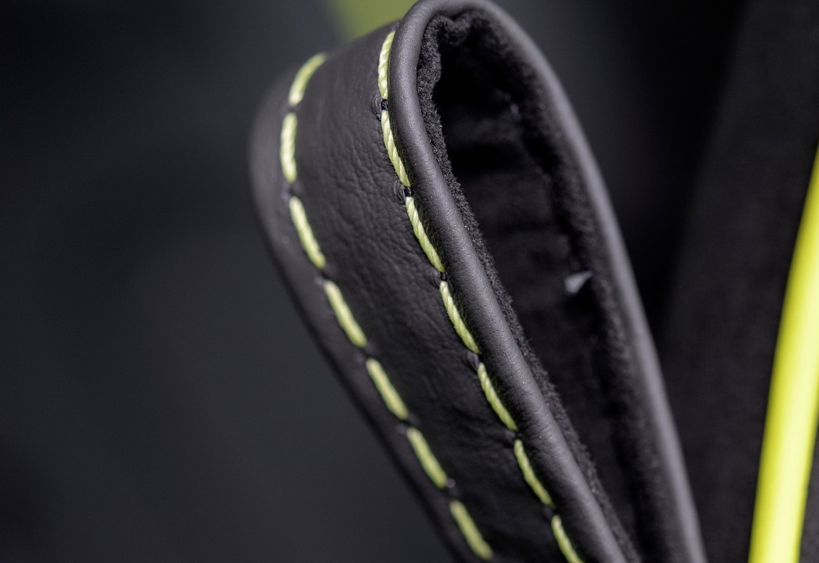 aston, green color, copy space, black color, 720P, single object, selective focus, extreme close-up, black background, focus on foreground, studio shot, HD Wallpaper