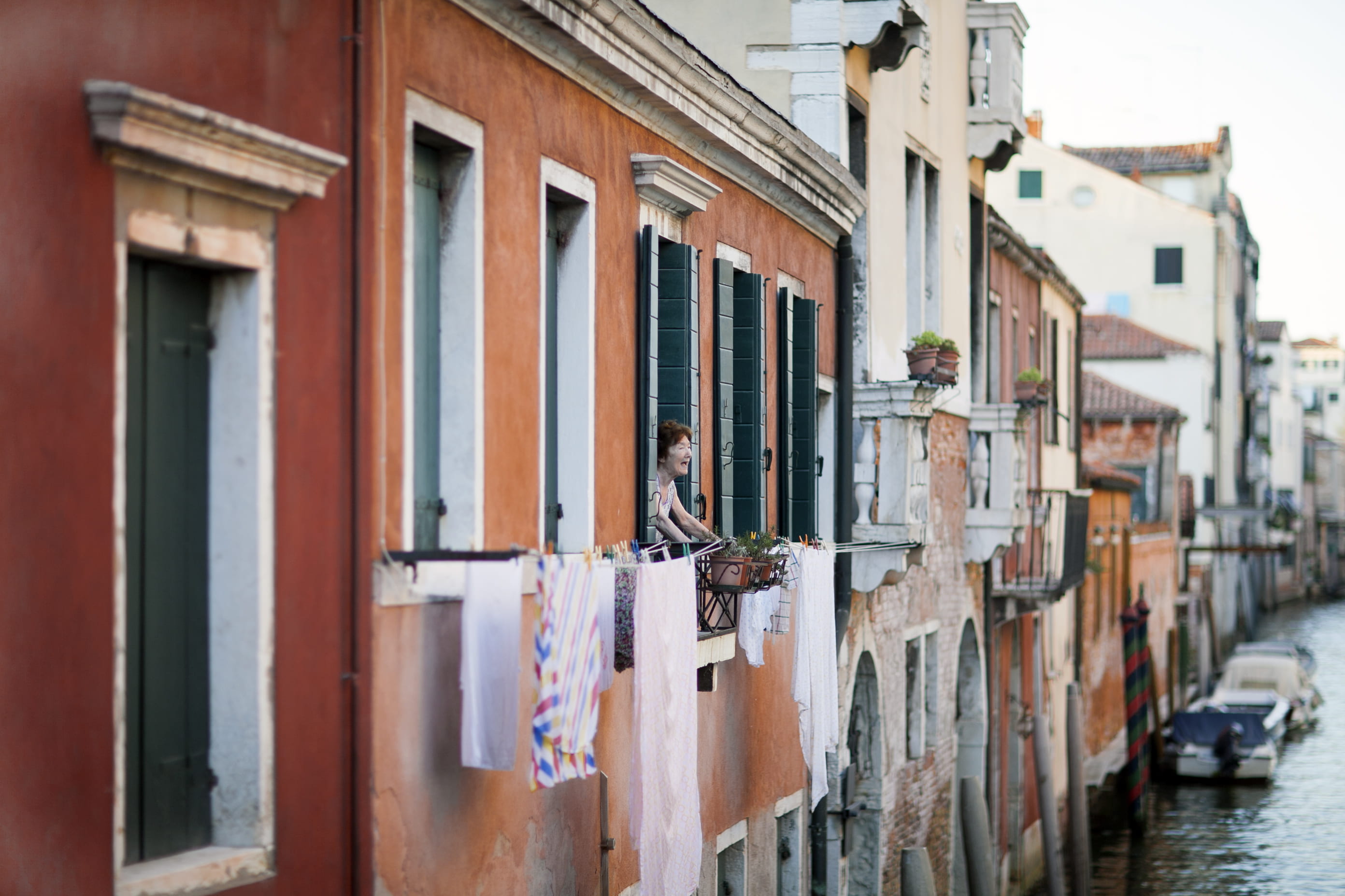 daytime, washing, built structure, clothing, hanging, row house, clothesline, drying, balcony, person, water, building, wood - material, alley, window, HD Wallpaper