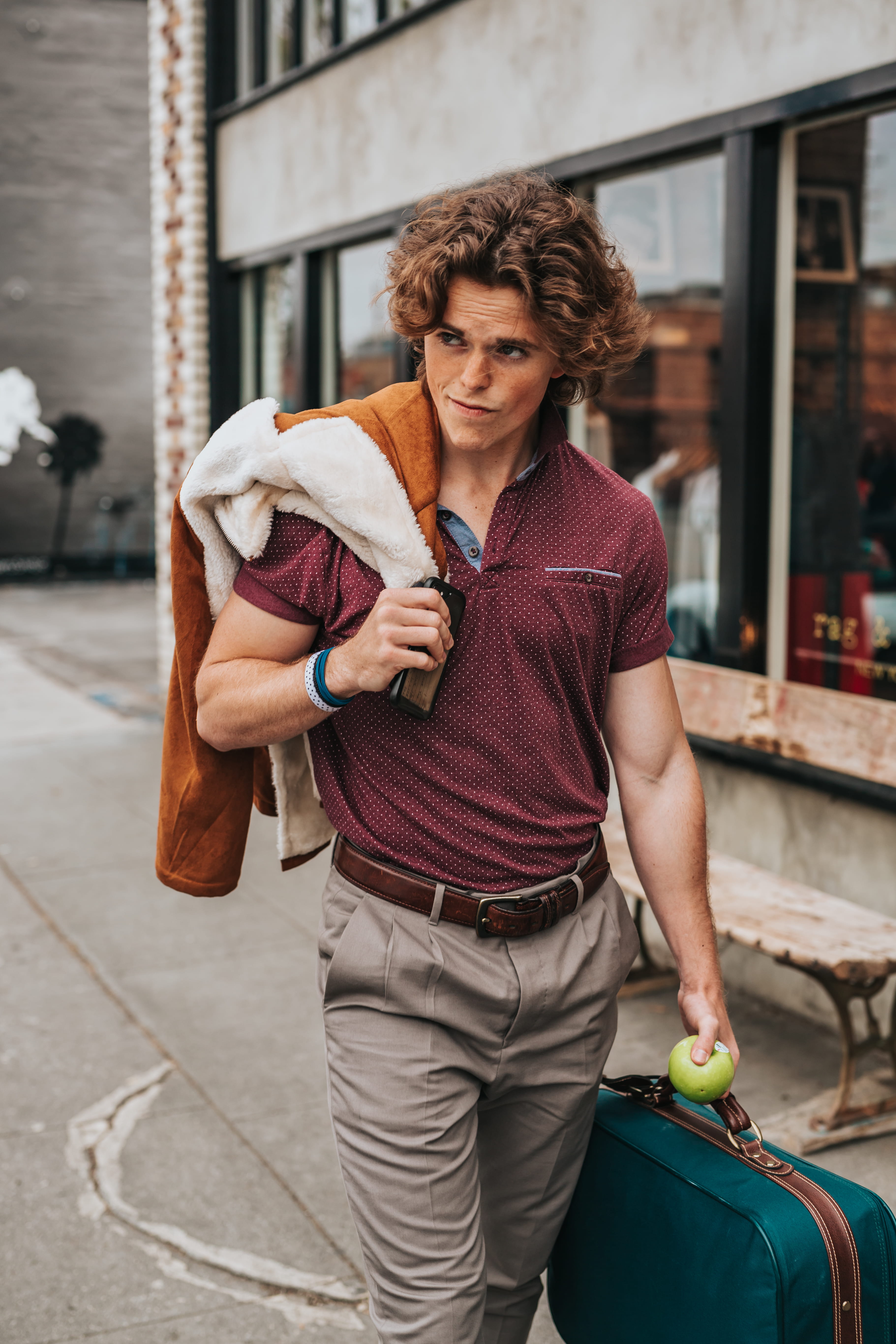 hairstyle, day, suitcase, walking, smart phone, outdoors, holding, lifestyle, communication, person, casual clothing, smartphone, 5K, belt, jacket, real people, Phone HD Wallpaper