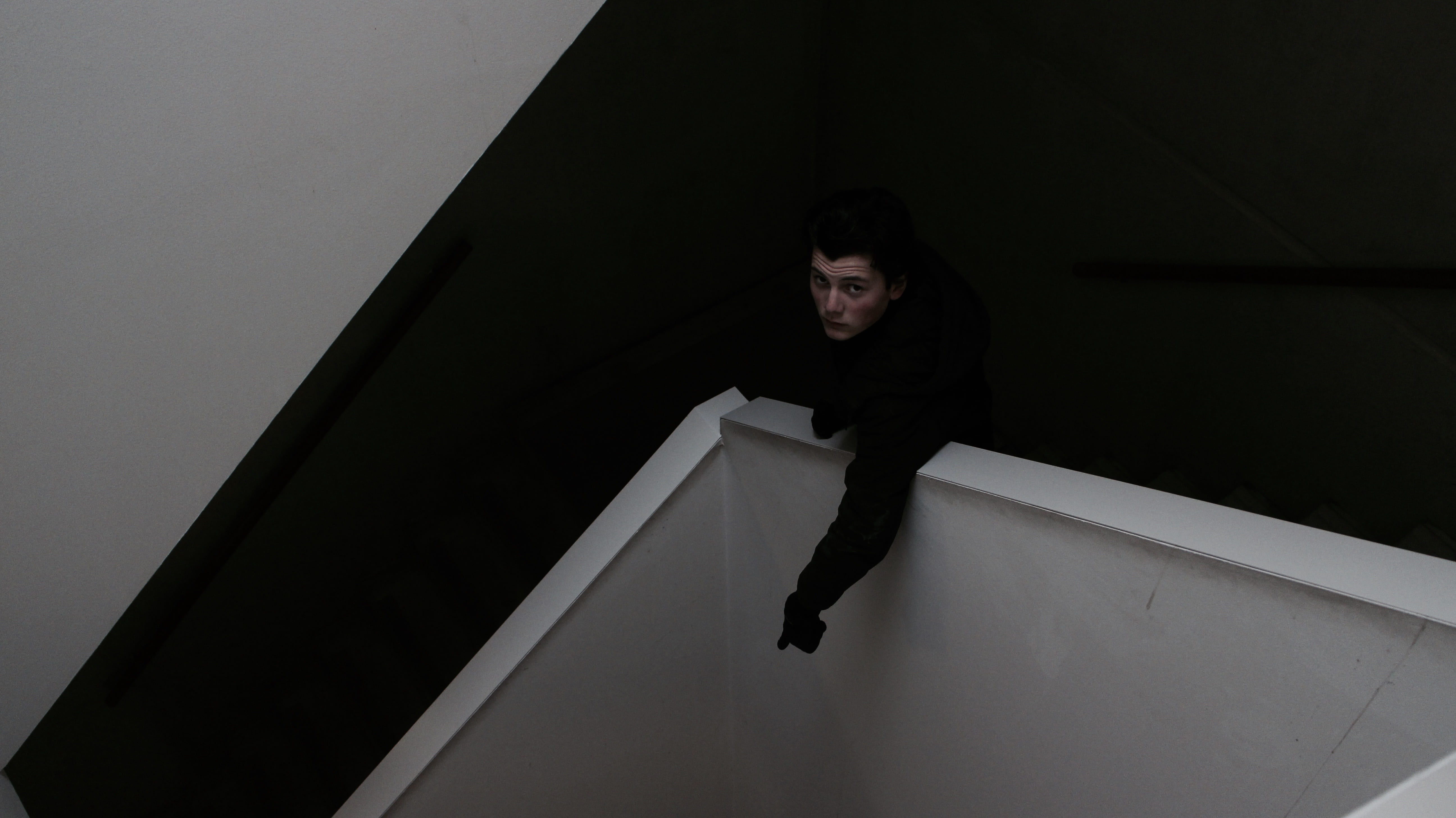 steps and staircases, looking at camera, man, cubicle, night, emotion, men, headshot, one person, young adult, 5K, indoors, front view, high angle view, HD Wallpaper
