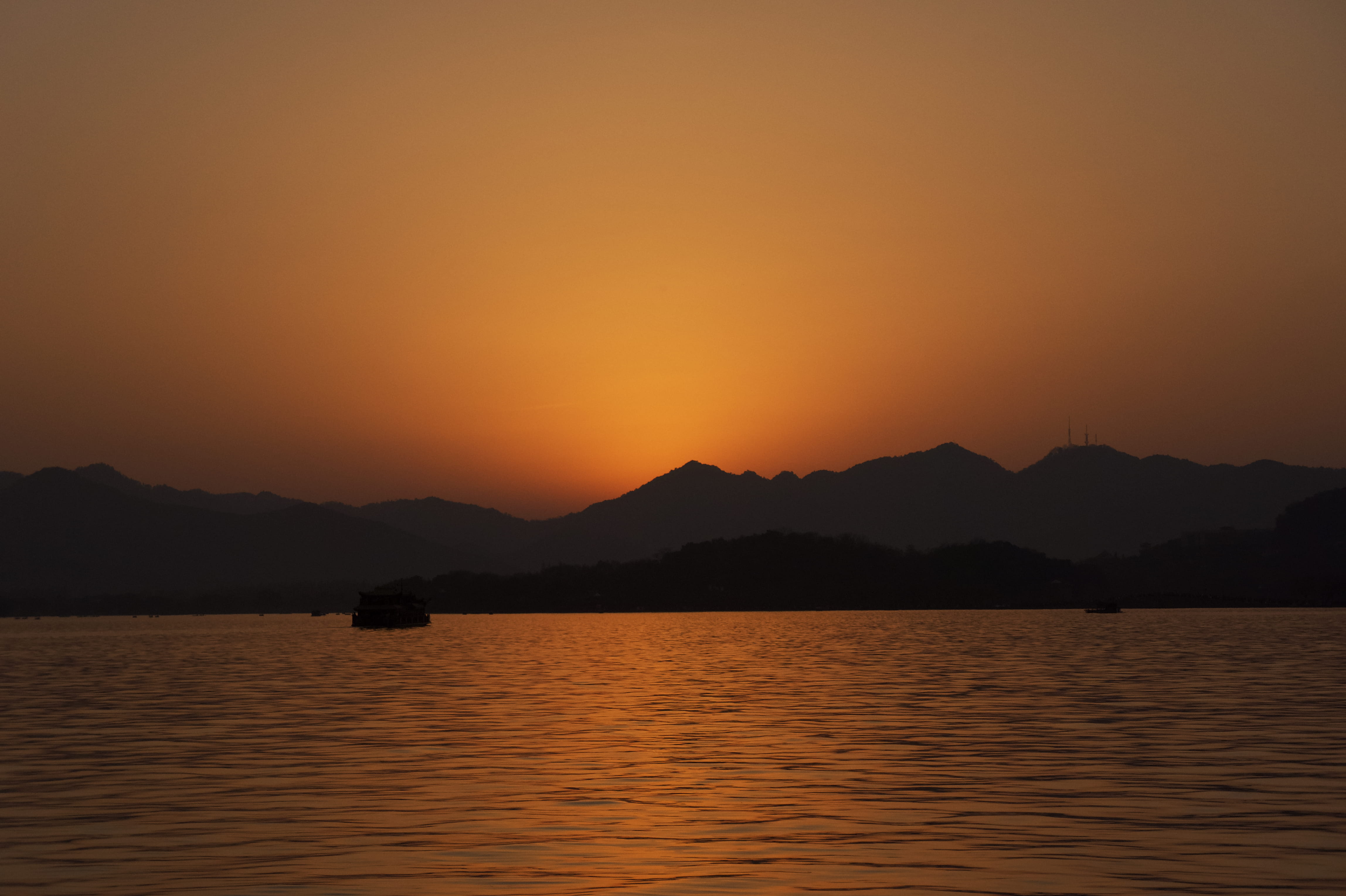 dusk, sunset, west lake, china, silhouette, waterfront, no people, outdoors, tranquility, mountain, boat, orange color, water, last light, romantic sky, HD Wallpaper