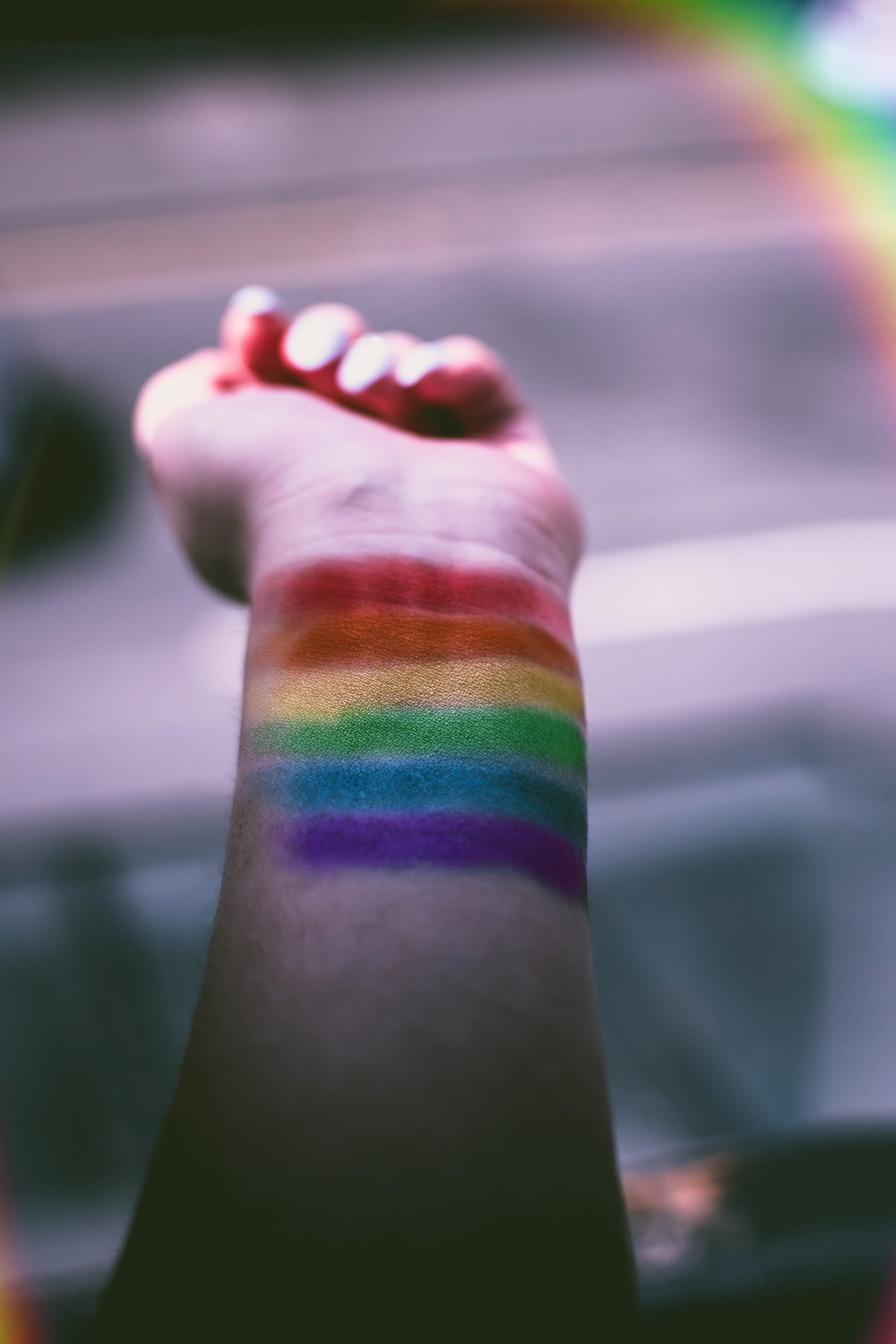 person, selective focus, personal perspective, day, woman, indoors, action, multi colored, paint, color, motley, recreation, flag, hand, focus on foreground, Phone HD Wallpaper