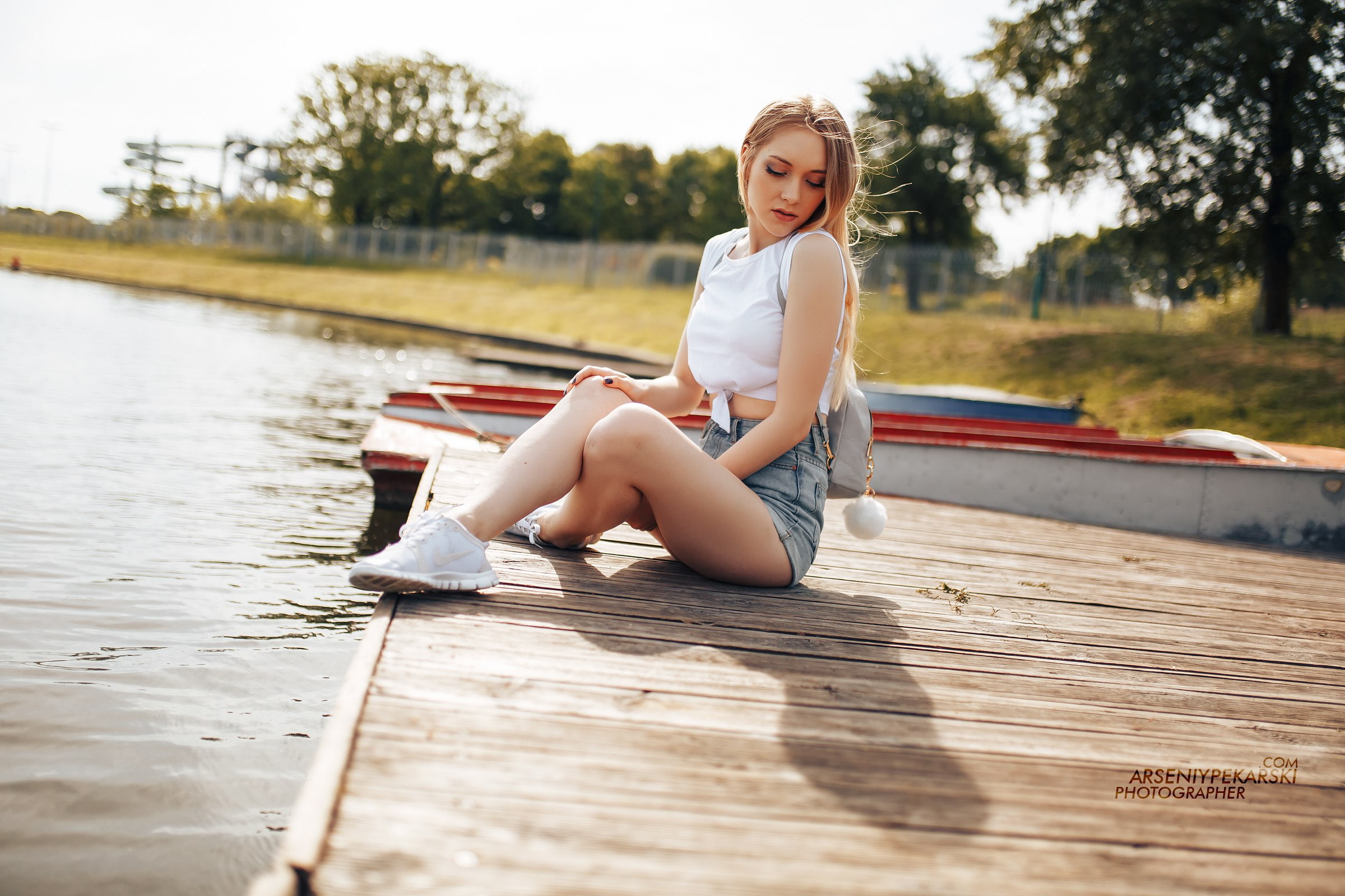 women outdoors, 1080P, Nike, one person, sunlight, sitting, casual clothing, real people, jean shorts, outdoors, women, boat, girls, full length, looking at camera, HD Wallpaper