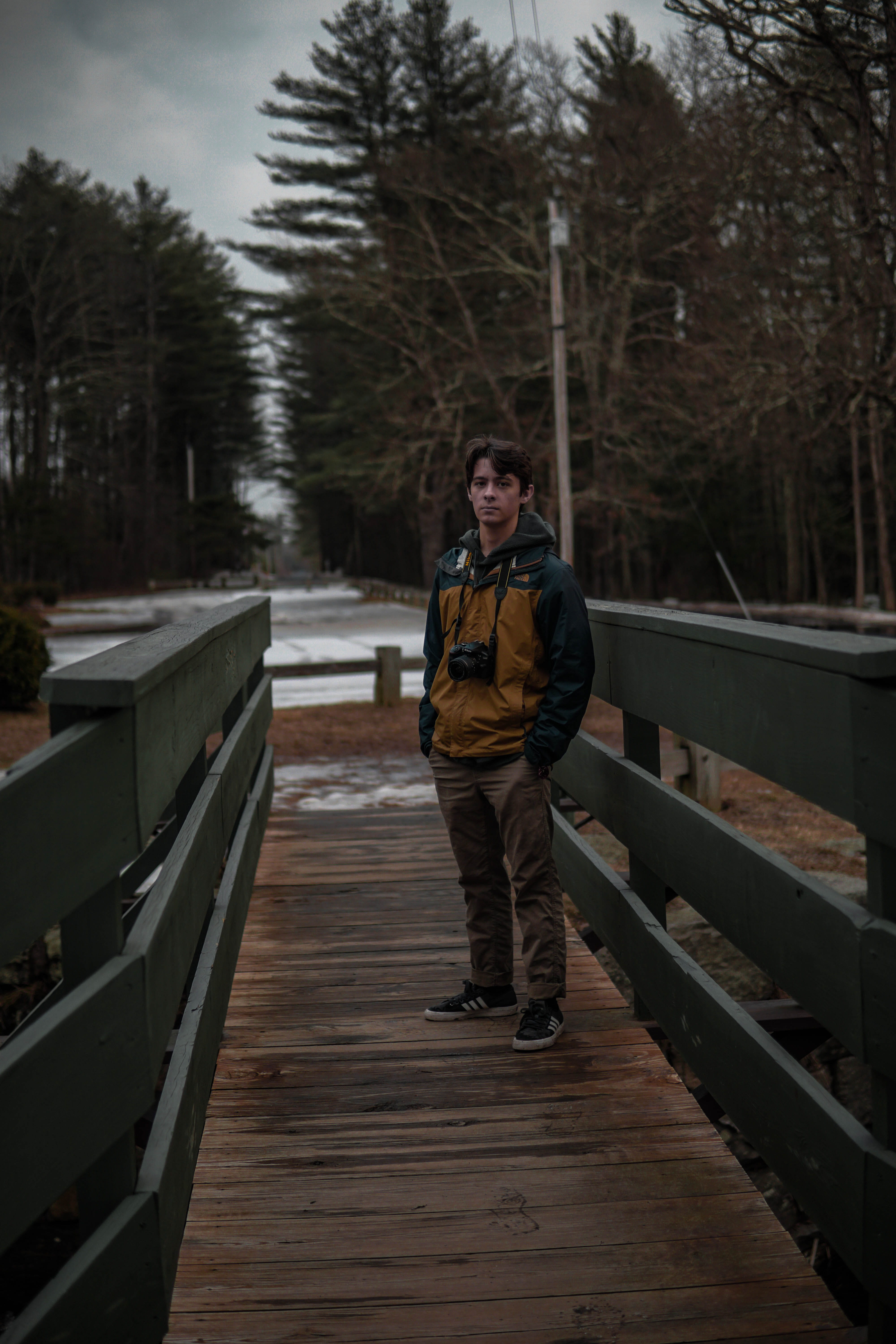 footwear, bridge, real people, water, pier, one person, boardwalk, waterfront, pants, front view, portrait, human, shoe, teenager, apparel, tree, winter, Phone HD Wallpaper