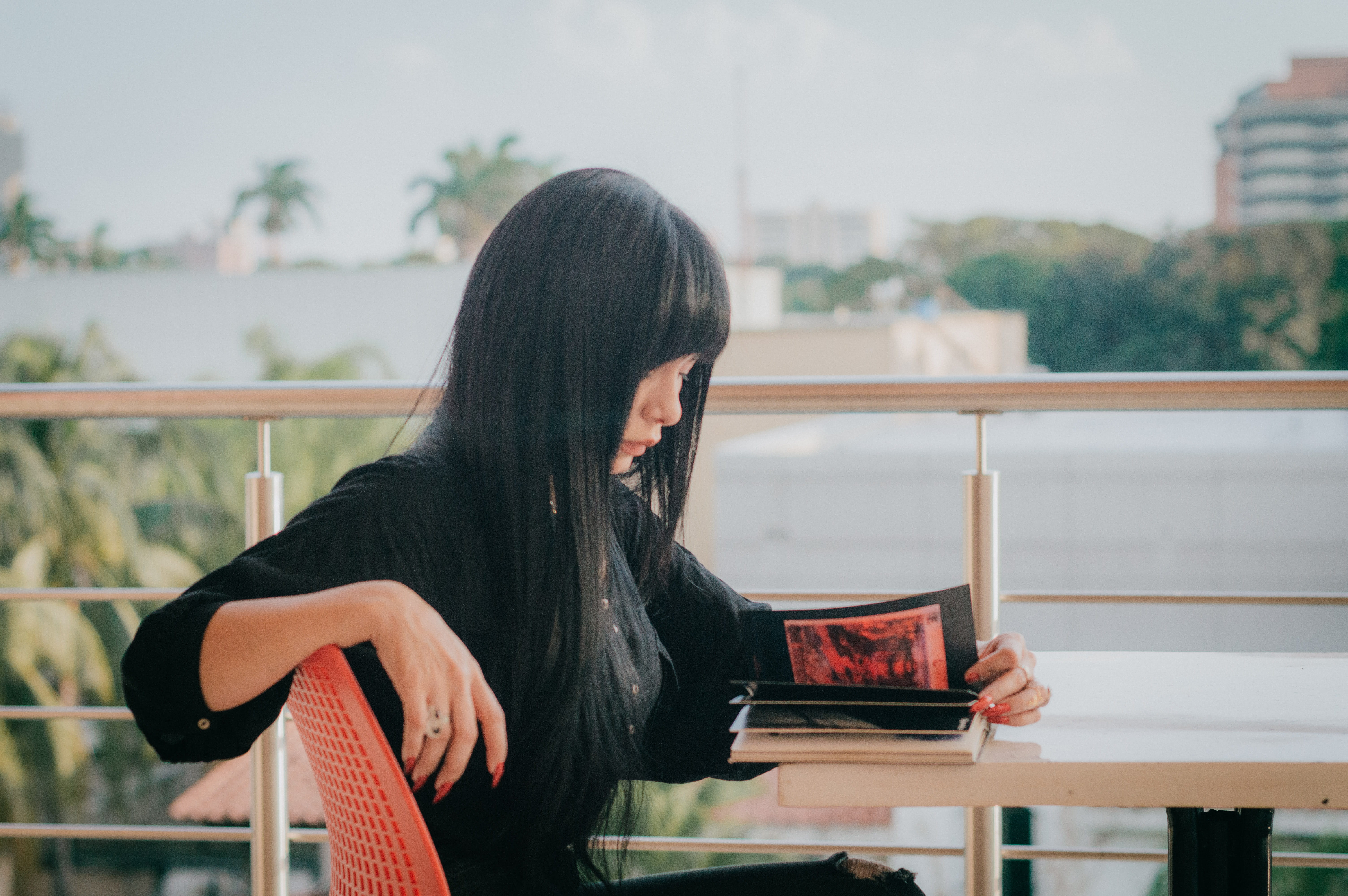 waist up, clothing, balcony, railing, shirt, couch, human, casual clothing, handrail, black, table, album, holding, standing, shelf, person, reading, lifestyles, HD Wallpaper