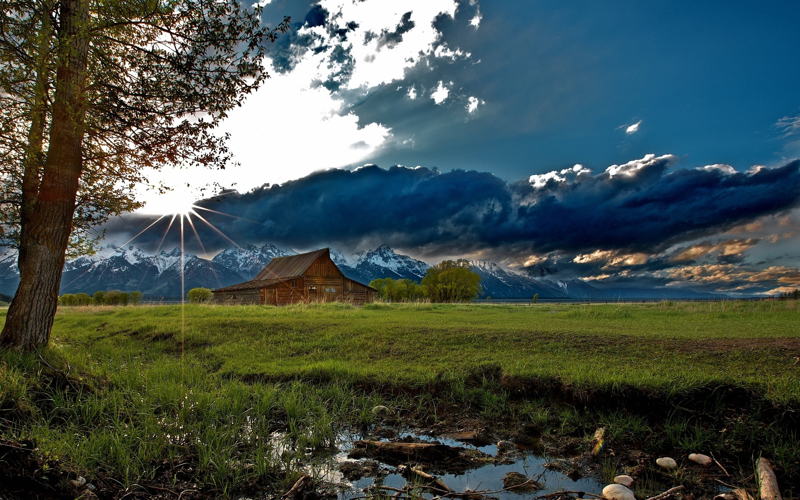 grass, outdoors, cloud - Sky, village, agriculture, tranquility, mountain, sunlight, growth, sun, beams, green Color, barn, environment, tree, scenics - nature, HD Wallpaper