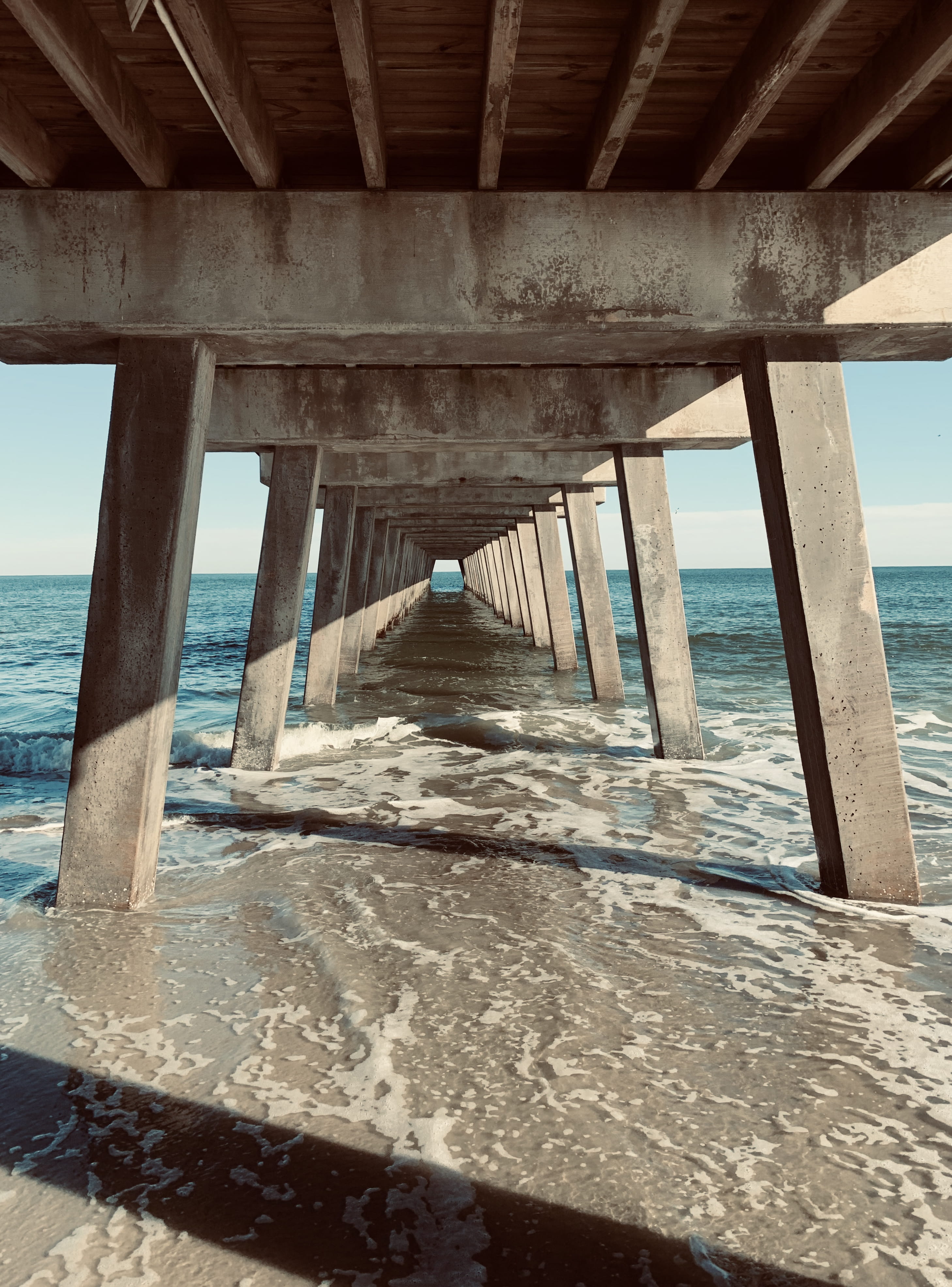 architectural column, underneath, no people, coast, seashore, wood - material, water, 4K, gray, ocean, united states, architecture, beach, sky, diminishing perspective, Phone HD Wallpaper