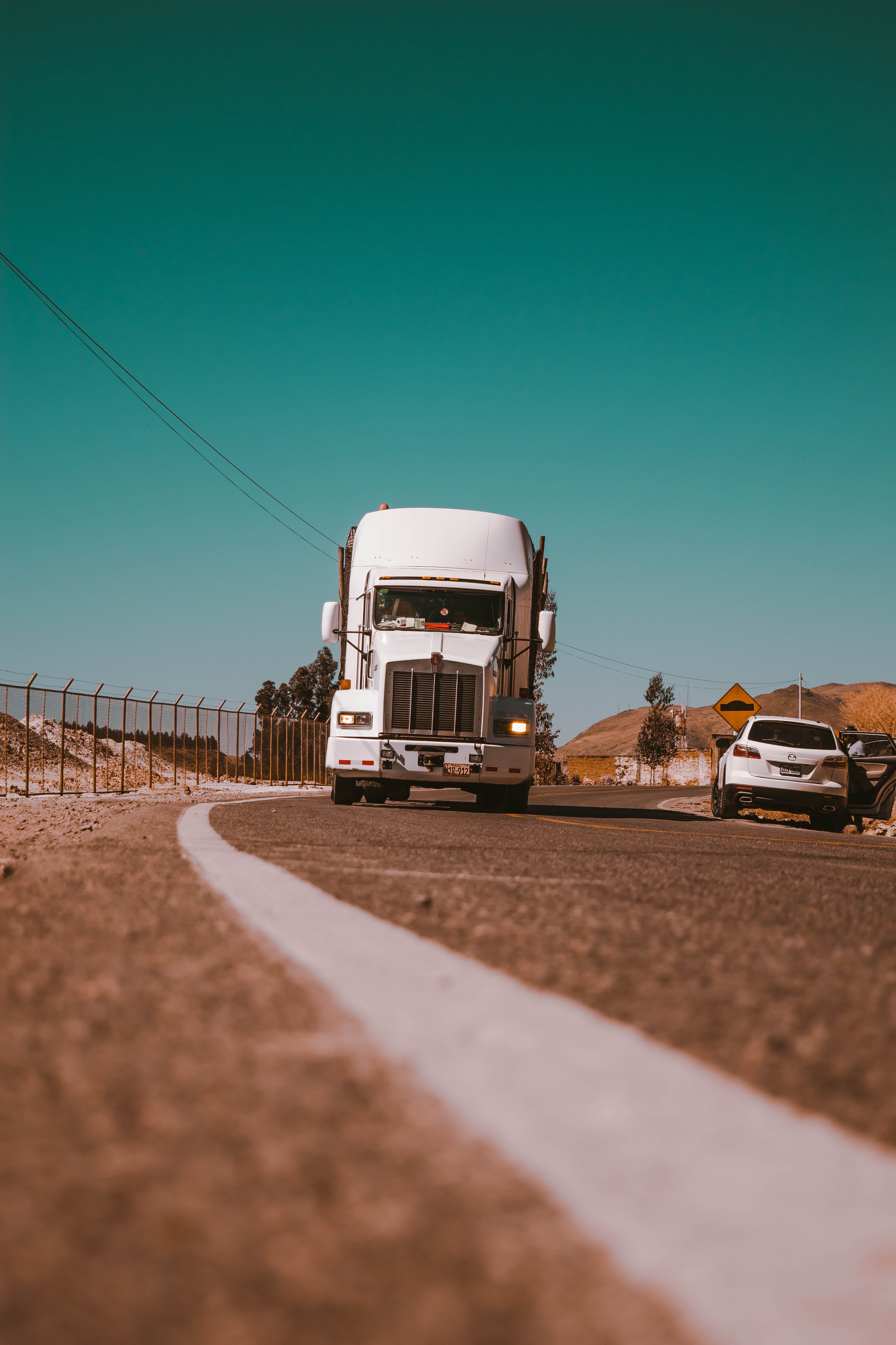 driving, color, freight, white line, land, 5K, truck, sand, surface level, sunlight, van, suv, beside, selective focus, copy space, paisaje, lorry, minimalism, Phone HD Wallpaper