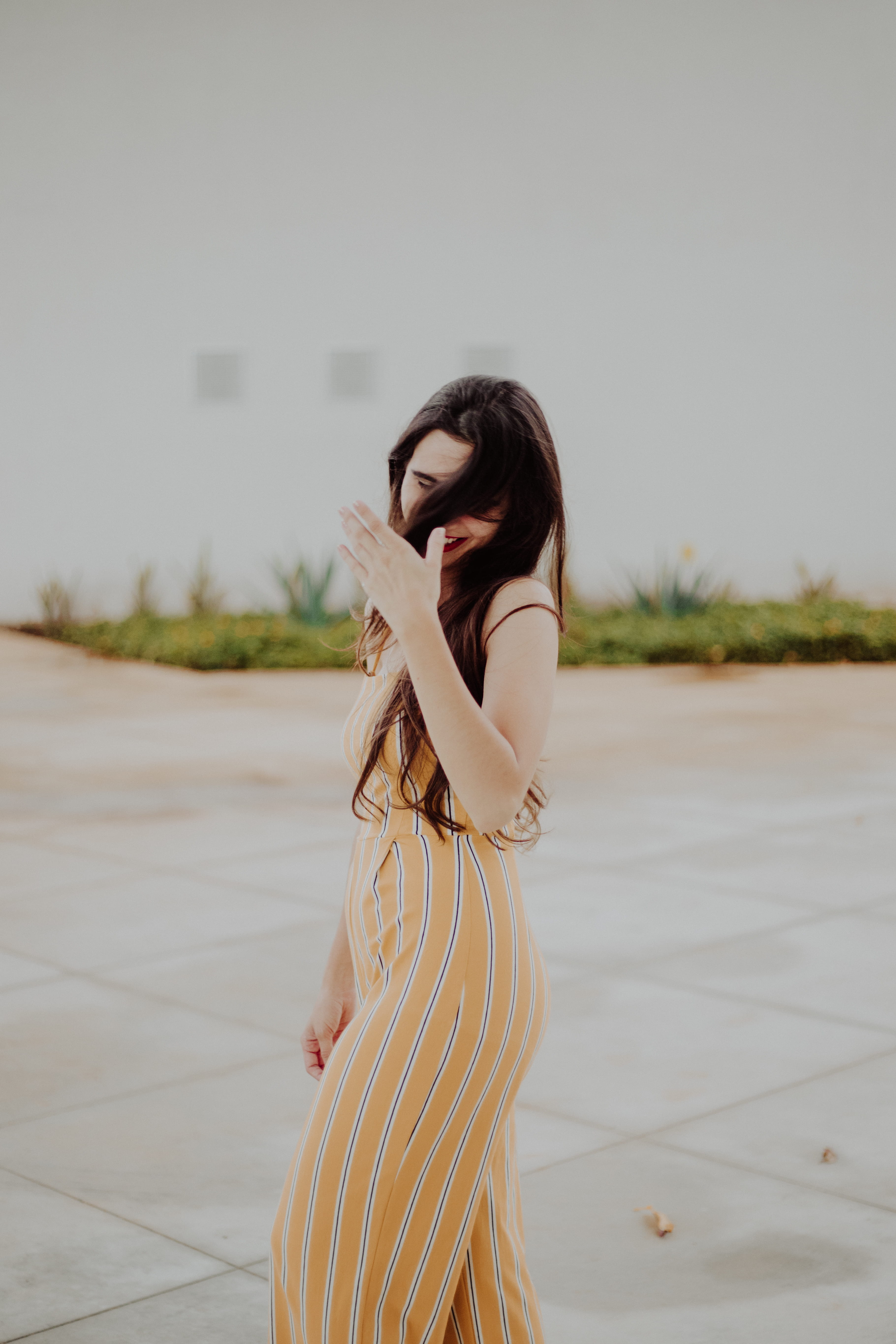 young adult, hairstyle, fashion, outdoors, female, onepiece, smile, portrait, jumpsuit, 5K, beautiful woman, women, lifestyles, beauty, three quarter length, Phone HD Wallpaper