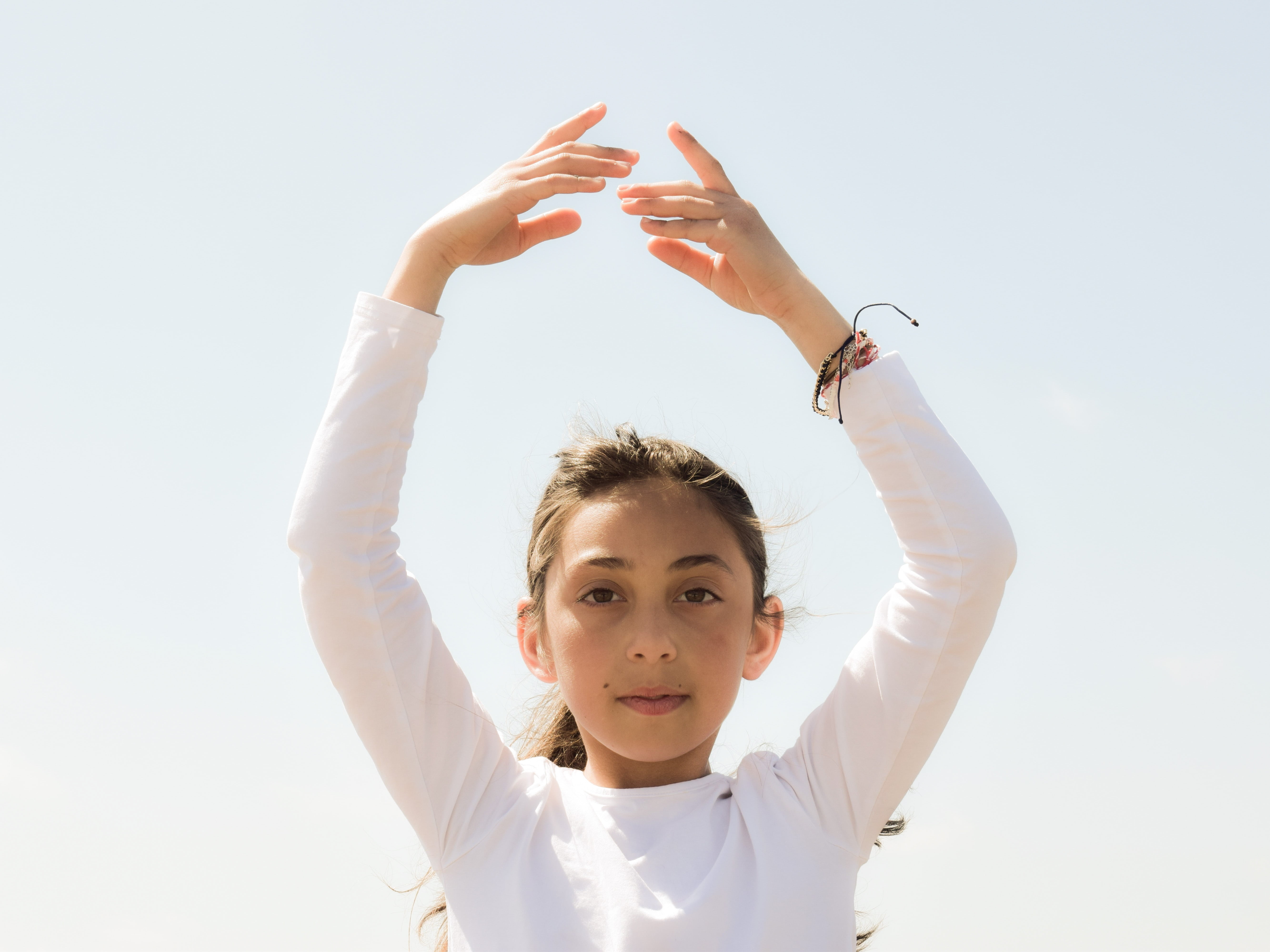 child, 5K, front view, light, children only, one girl only, hairstyle, girls, childhood, wellness, balance, sky, peace, hand, headshot, gesturing, looking at camera, HD Wallpaper