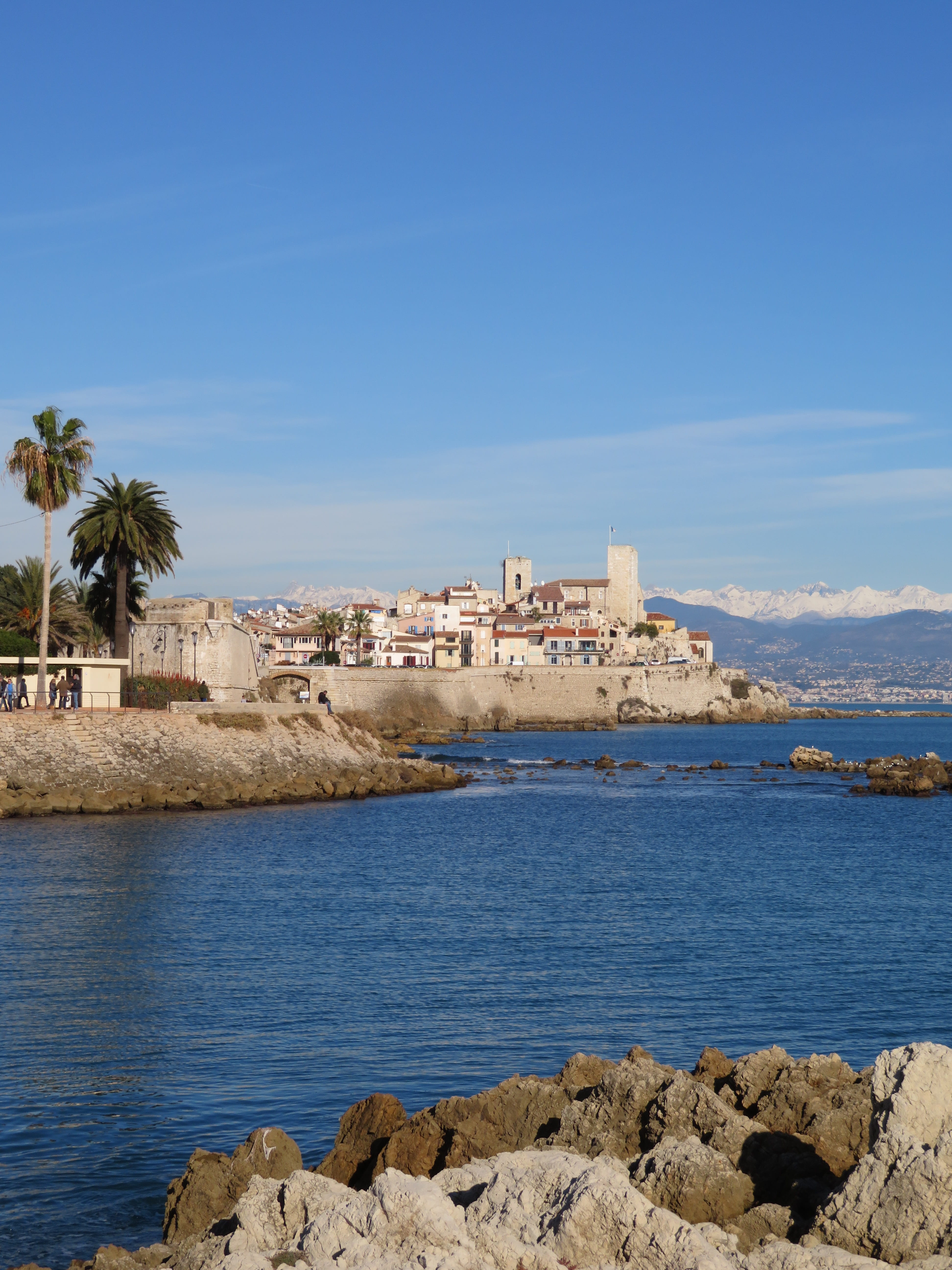 mountains, side, snow, sky, solid, land, village, antibes, plant, 5K, fort, winter, palm tree, water, sea, portrait, day, nature, building exterior, architecture, Phone HD Wallpaper
