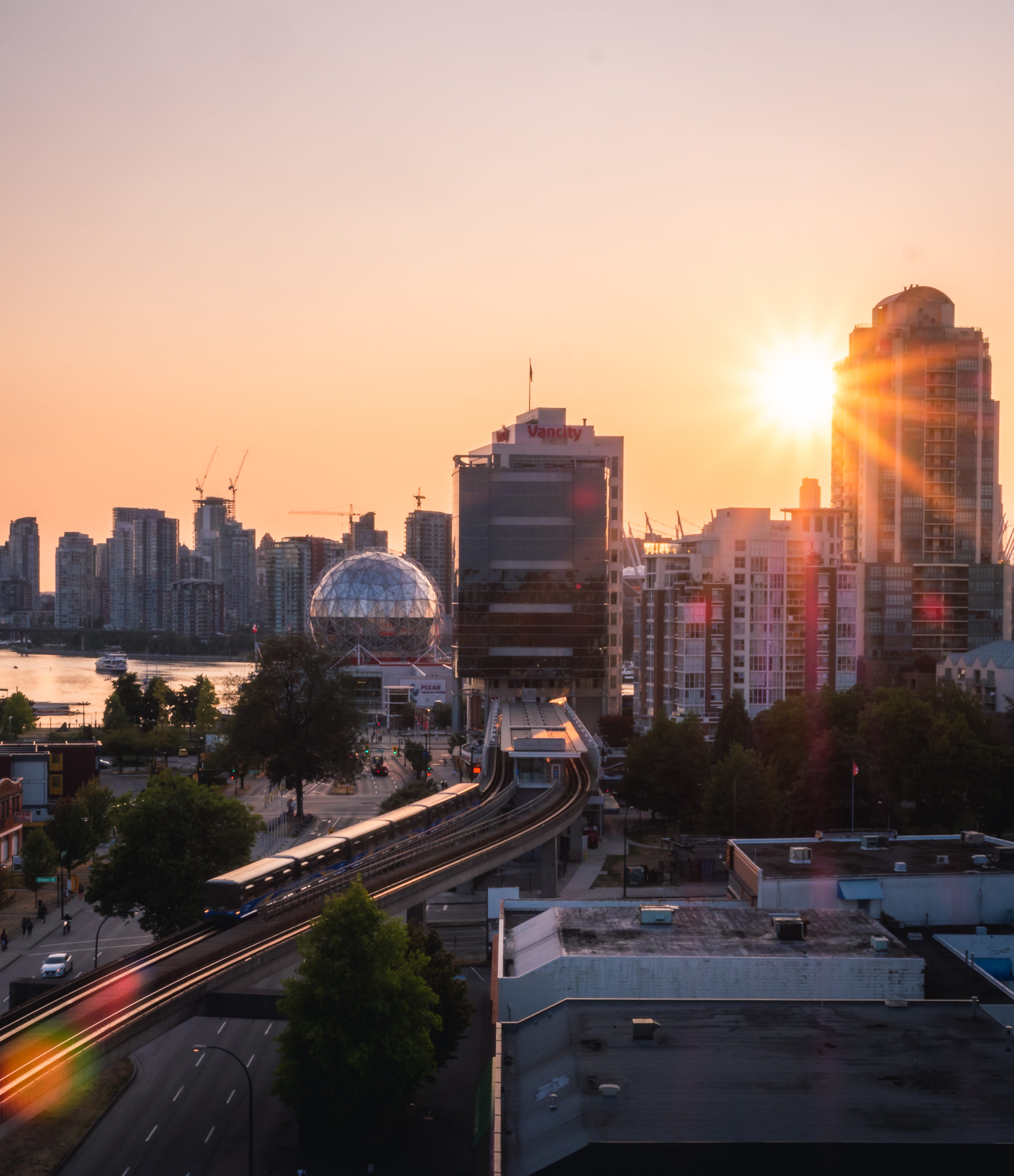 architecture, sunset, sun, 4K, lens flare, train, evening, motion, skyscraper, vancouver, building, road, sky, city street, mode of transportation, canada, Phone HD Wallpaper