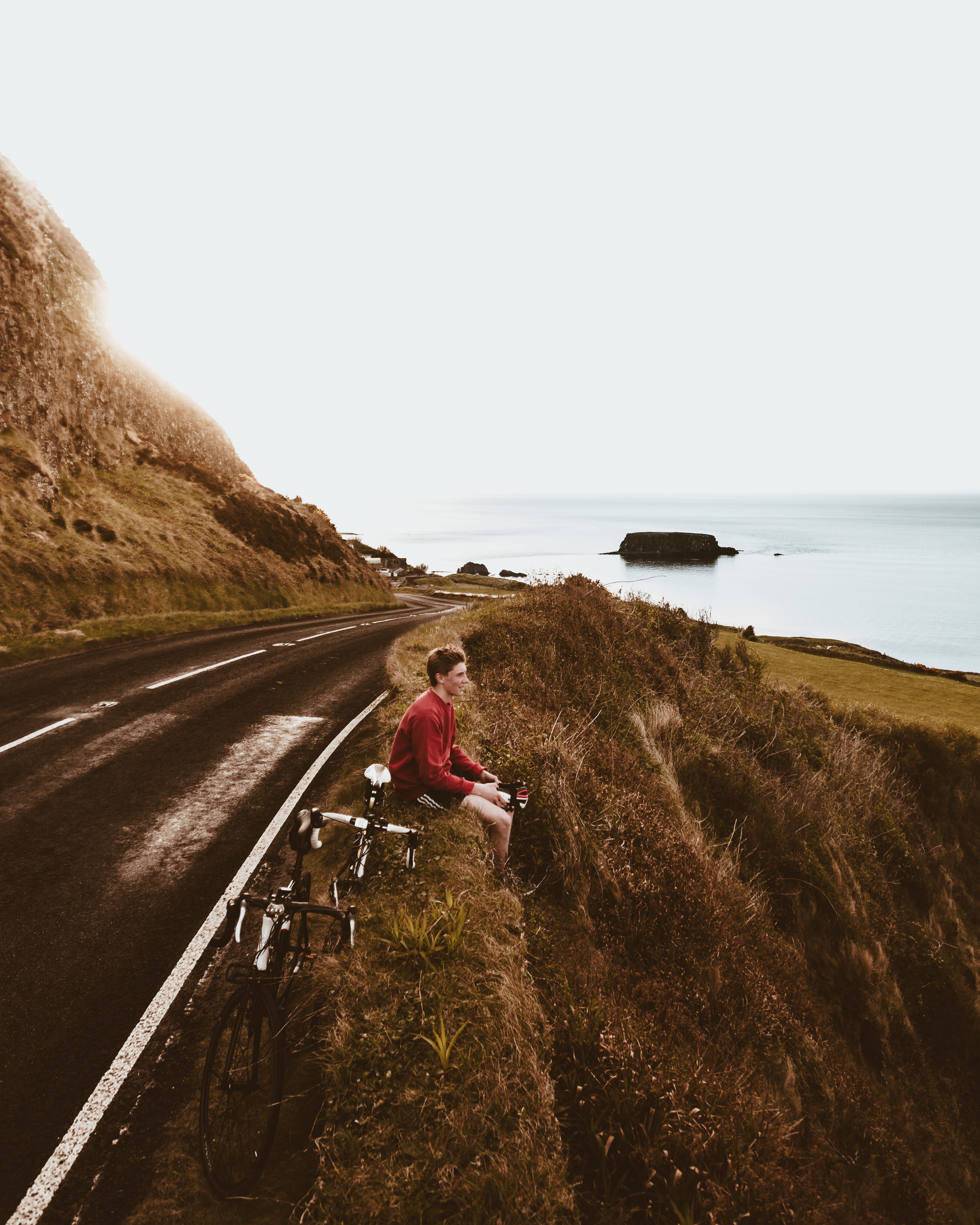 claud butler, northern ireland, moment, causeway coast, climb, copy space, sea, one person, land, clear sky, cycling, nature, island, road, giants causeway, Phone HD Wallpaper