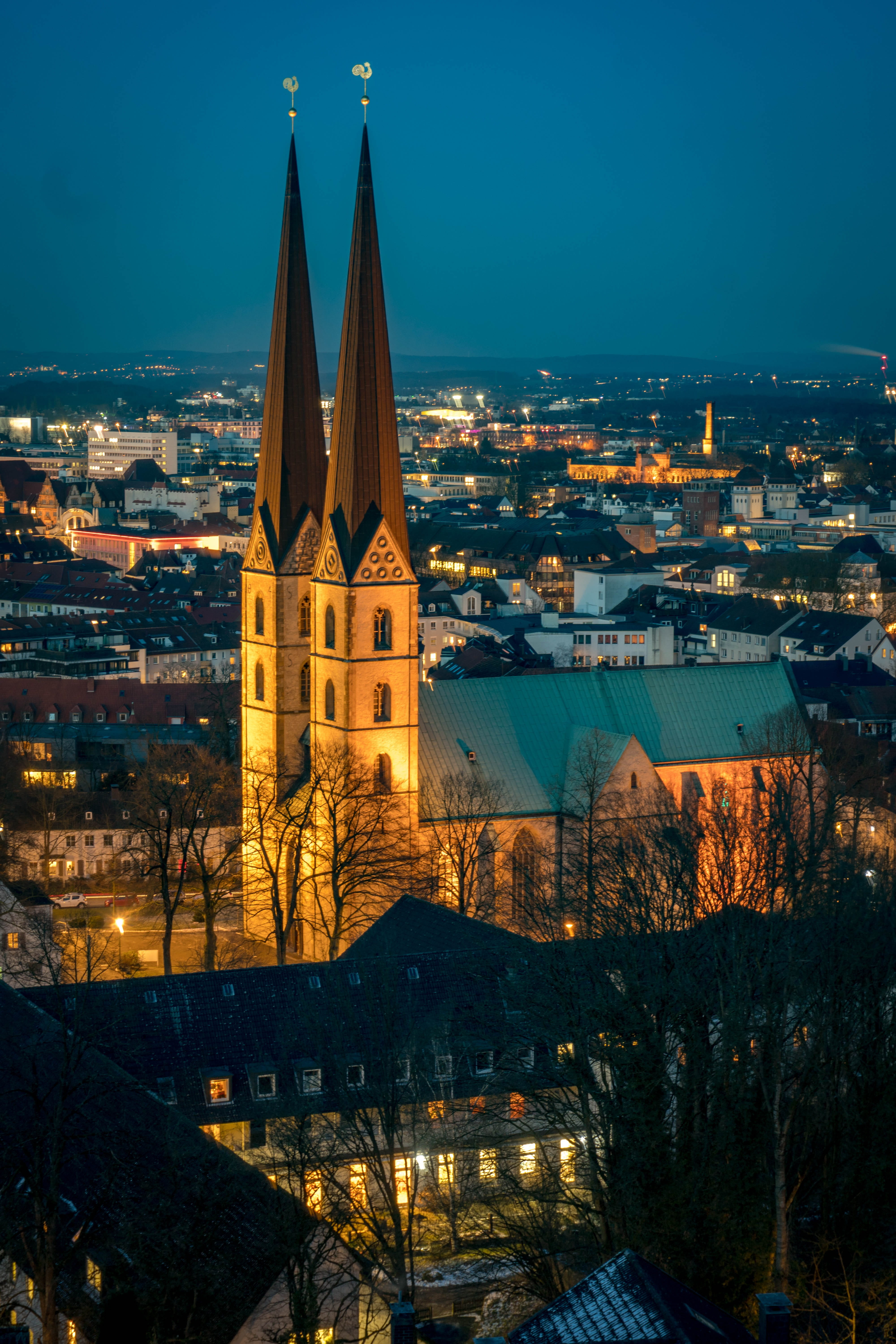 spires, night, 5K, bielefeld, illuminated, sky, cityscape, residential district, nature, travel, germany, urban landscape, spirituality, architecture, Phone HD Wallpaper