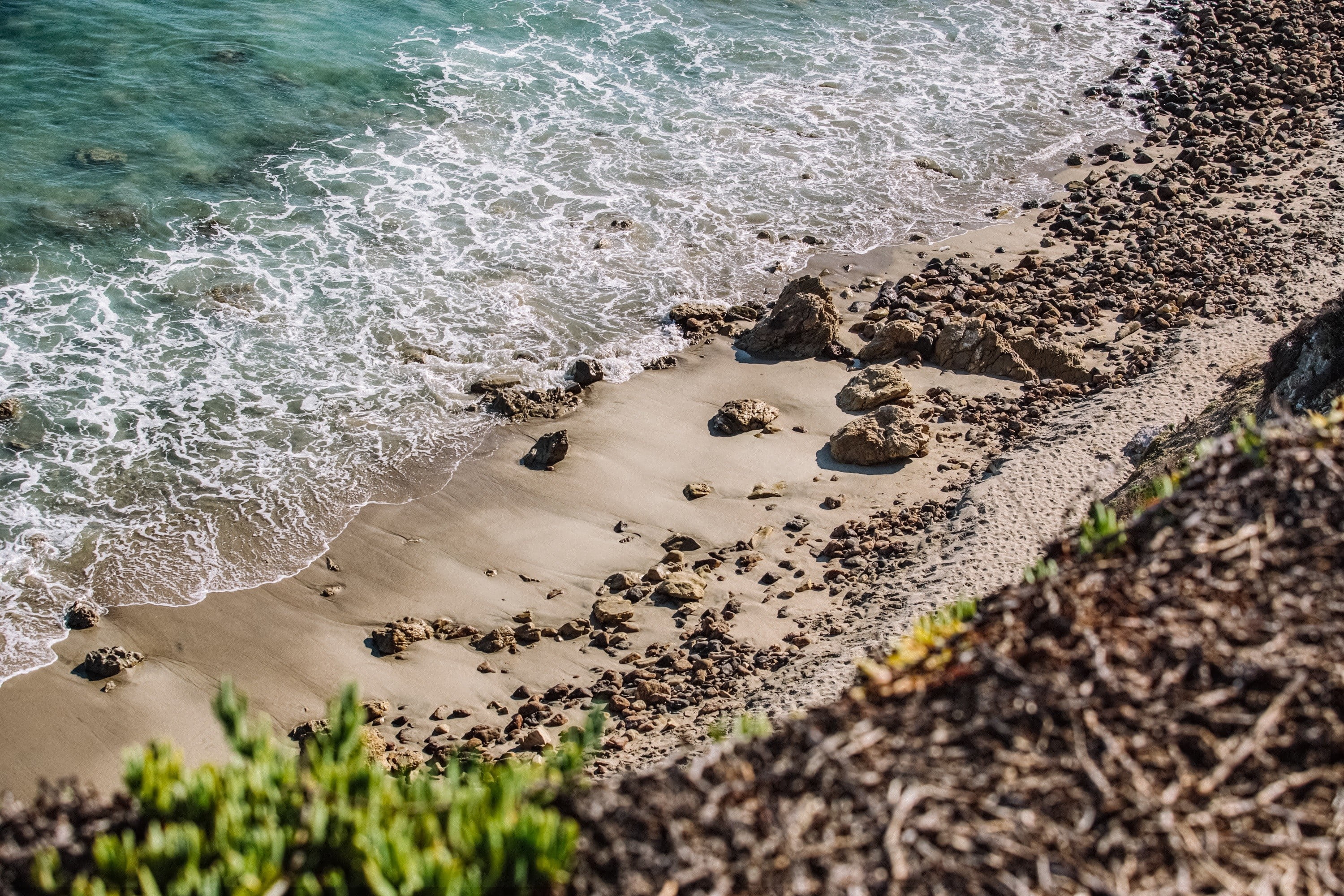 motion, sand, day, high angle view, sport, beach, rocks, solid, land, gray, sea, 2K, outdoors, wave, nature, sunlight, beauty in nature, aquatic sport, HD Wallpaper