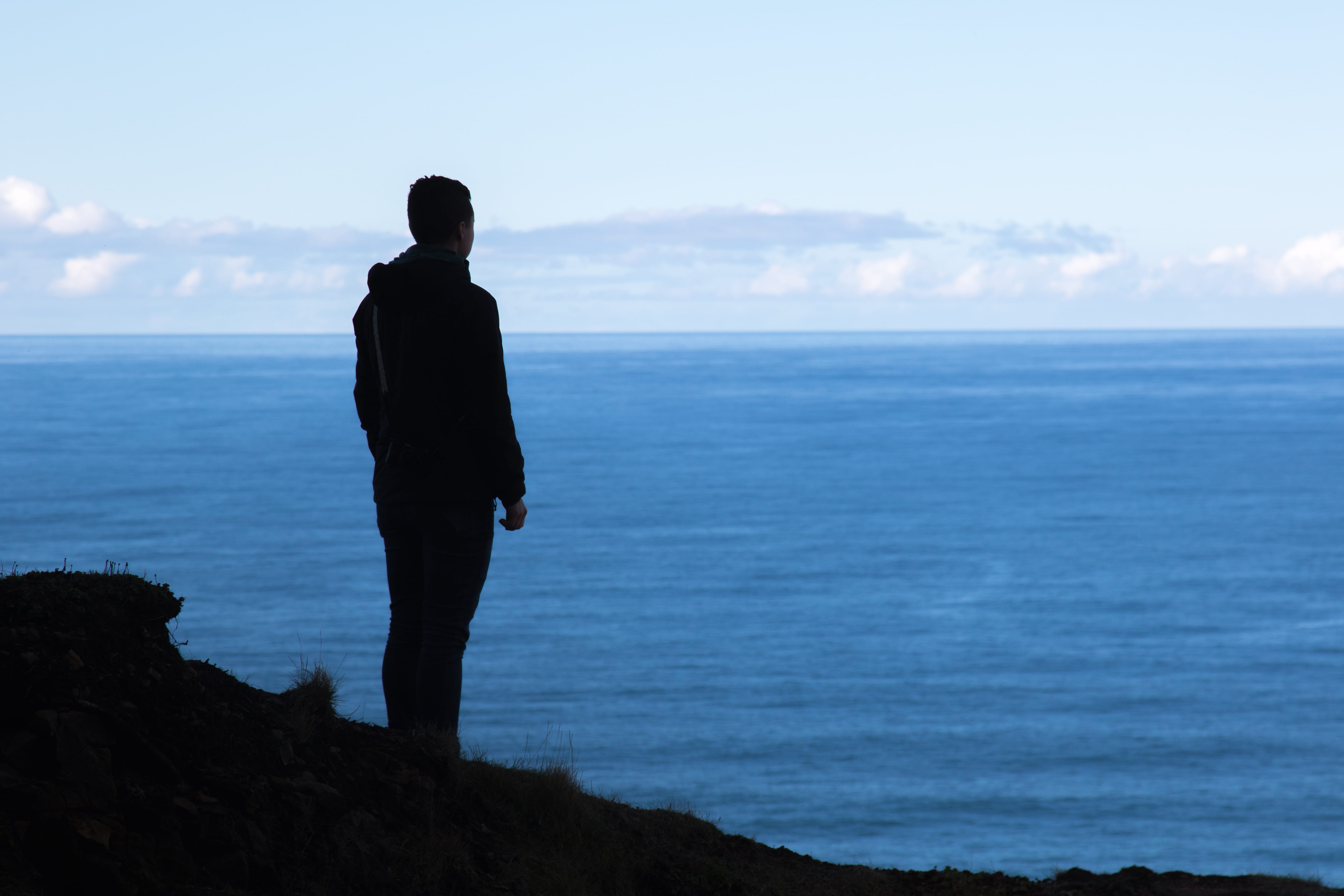 horizon, horizon over water, woman, beach, cliff, nature, near, lifestyles, standing, views, land, silhouette, real people, person, looking at view, body, HD Wallpaper