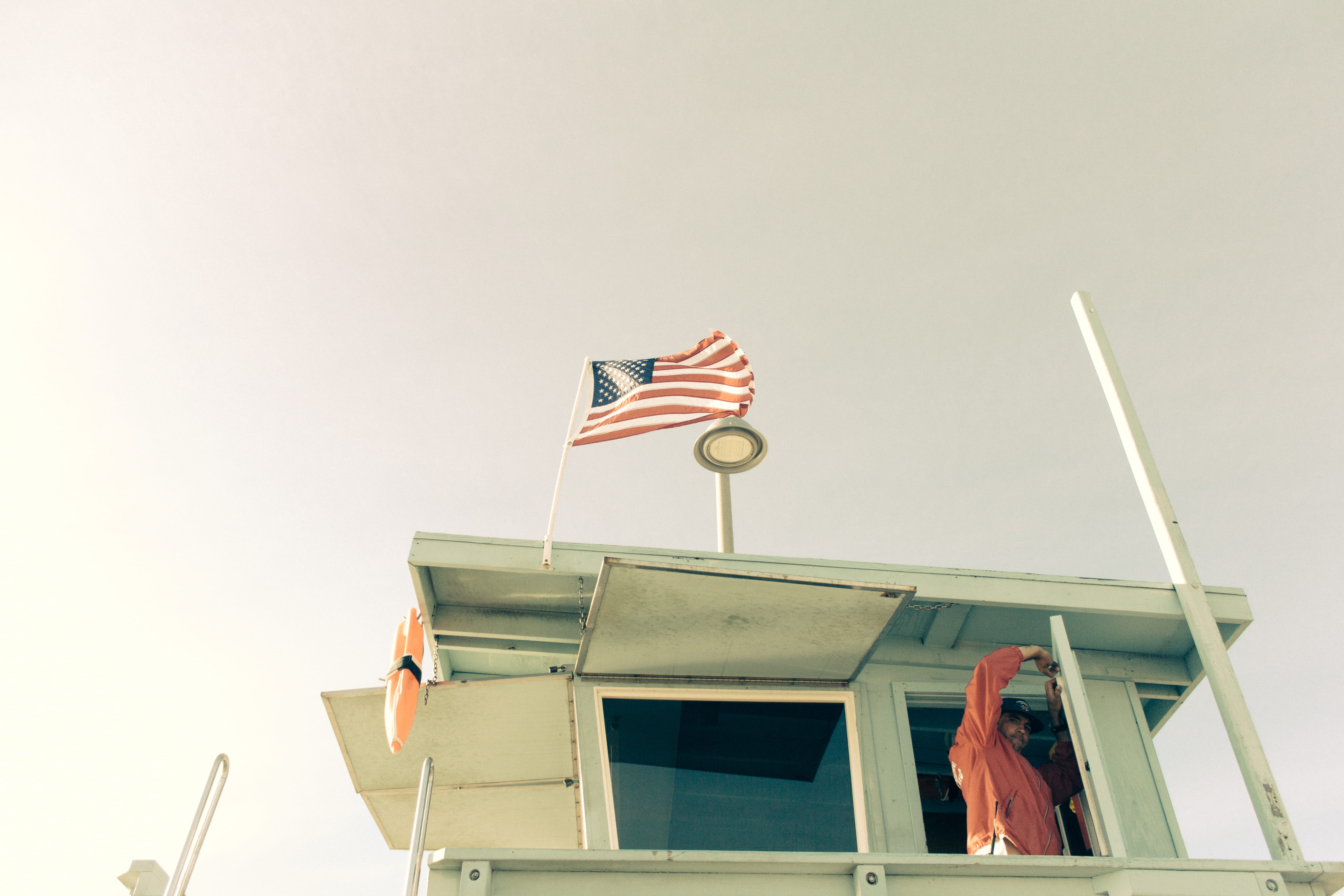 life preserver, lifeguard tower, american flag, sky, freedom, copy space, flag, building exterior, people, nature, wind, retro, lifeguard, sunny, low angle view, HD Wallpaper