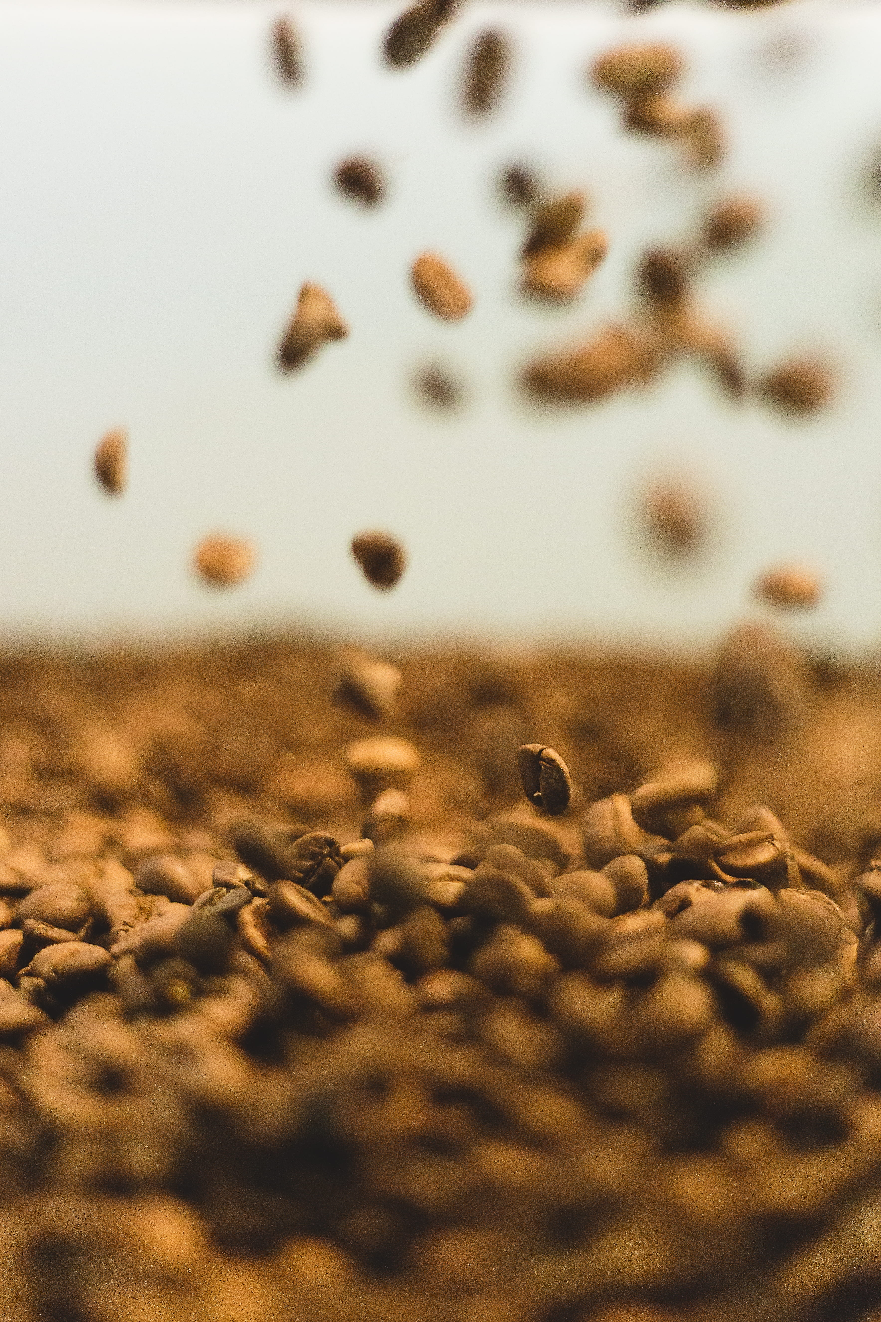 large group of objects, coffee, freshness, selective focus, table, closeup, tasty, abundance, nature, falling, day, coffeebean, food, brown, drink, close-up, Phone HD Wallpaper
