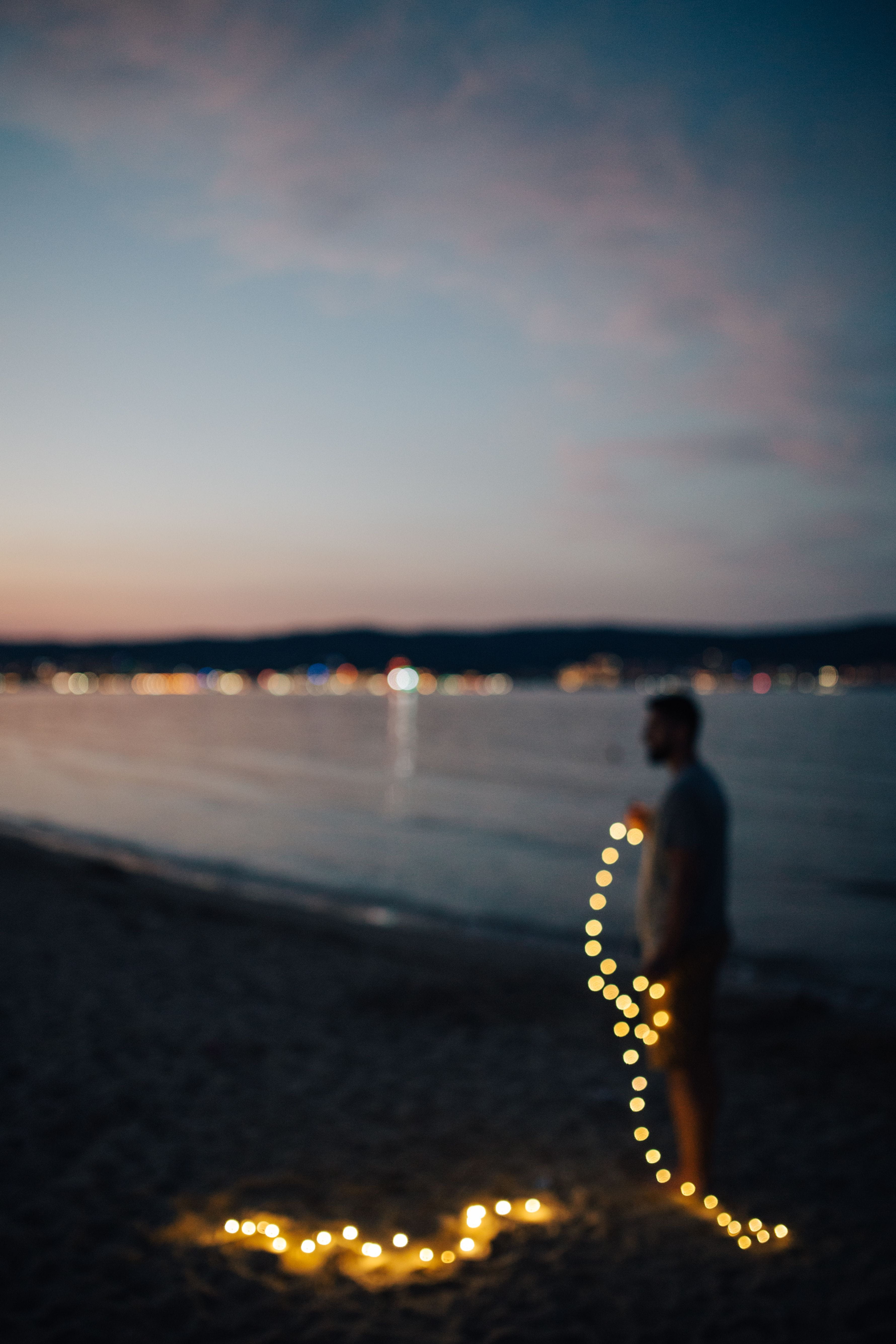 water, fairy, nature, rear view, bokeh, Fairy lights, Bulgaria, evening, beach, one person, night, outdoors, people, seaside, beauty in nature, land, leisure activity, Phone HD Wallpaper