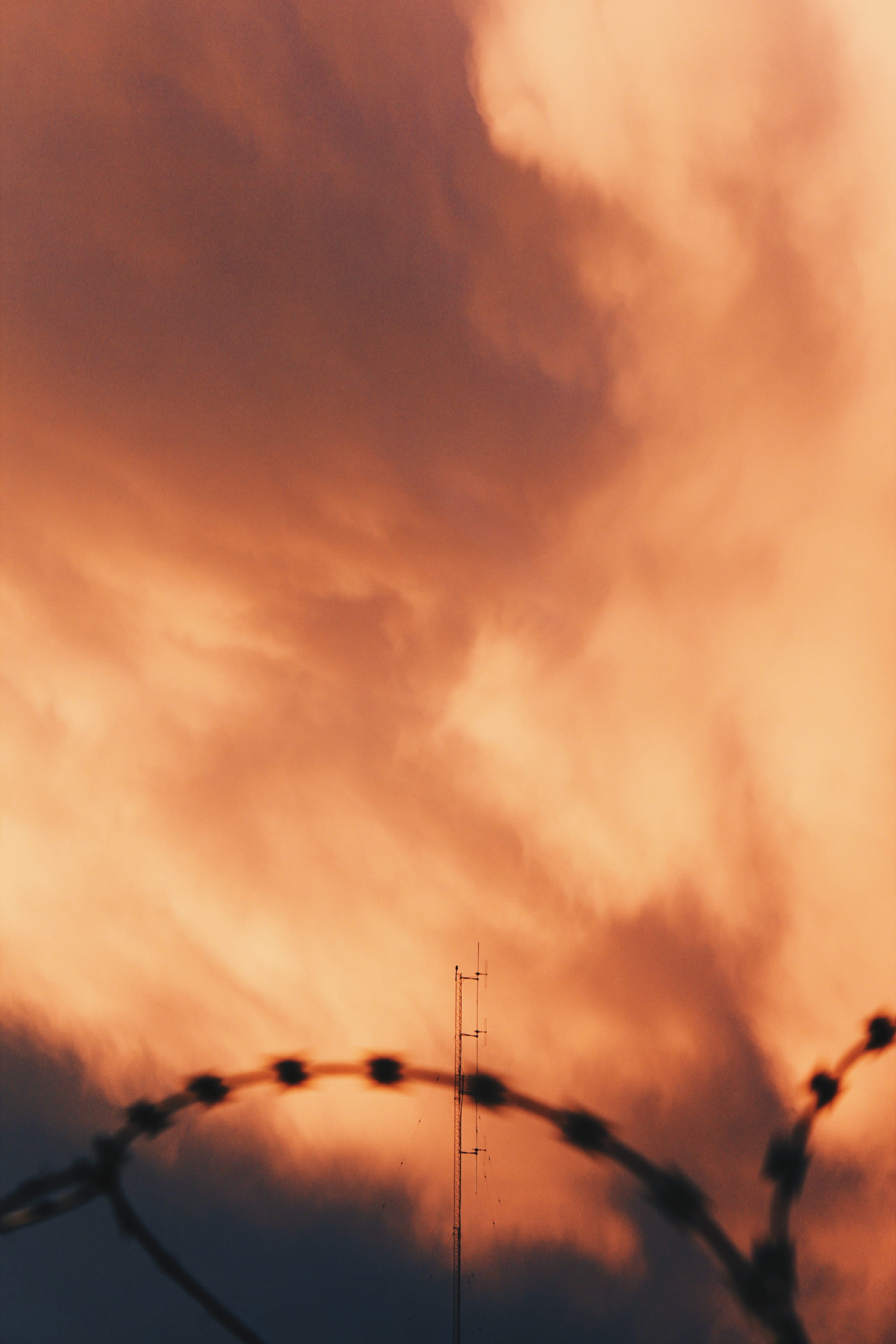 orange color, technology, cloud - sky, sunlight, dramatic sky, electricity, fence top, sunset, cloudscape, no people, tranquil scene, silhouette, environment, Phone HD Wallpaper