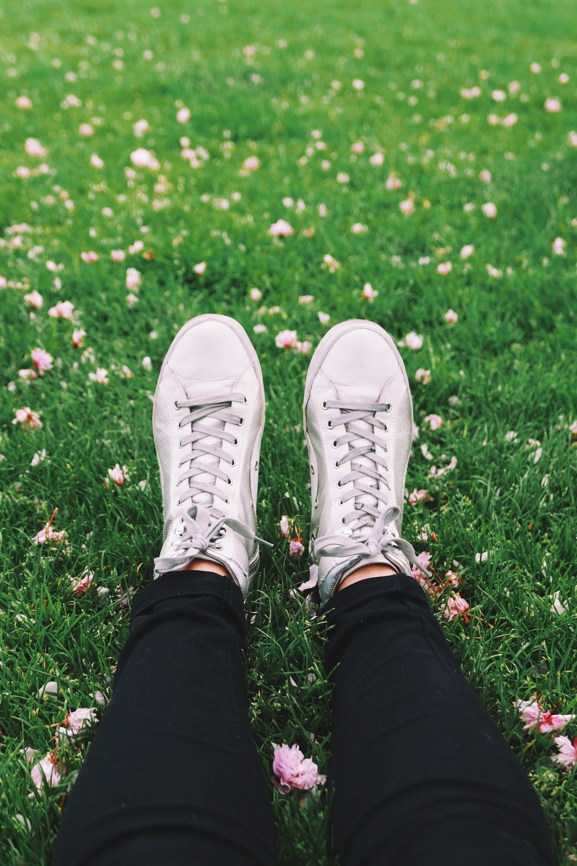 person, wearing, walking, laying, sport, grass, human Foot, gray, land, human limb, chill, one person, flower, jeans, footwear, people, personal perspective, Phone HD Wallpaper