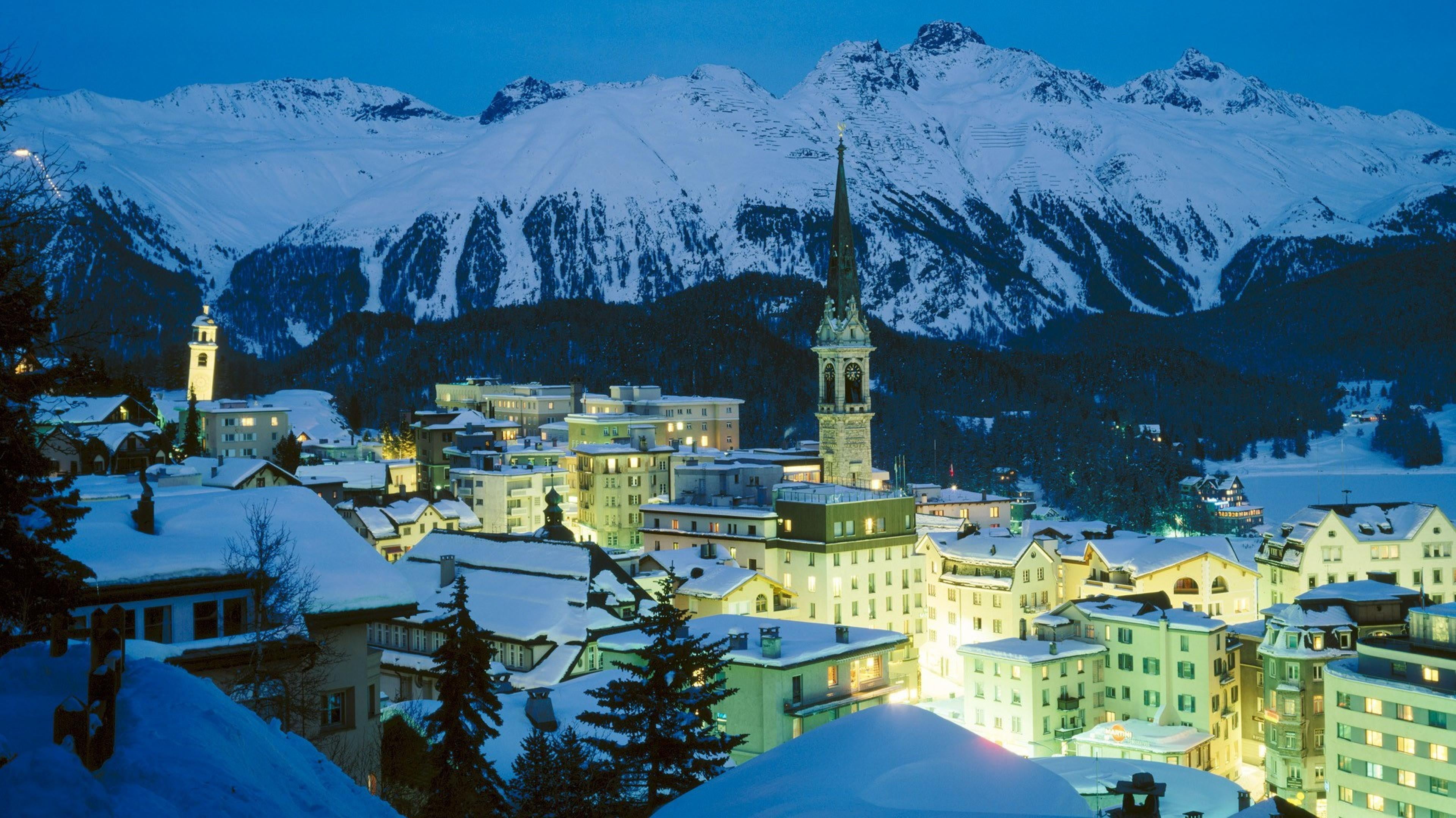 snowy, snowcapped mountain, city lights, building, city, tree, built structure, snow, alps, no people, religion, evening, 4K, nature, mountains, place of worship, HD Wallpaper