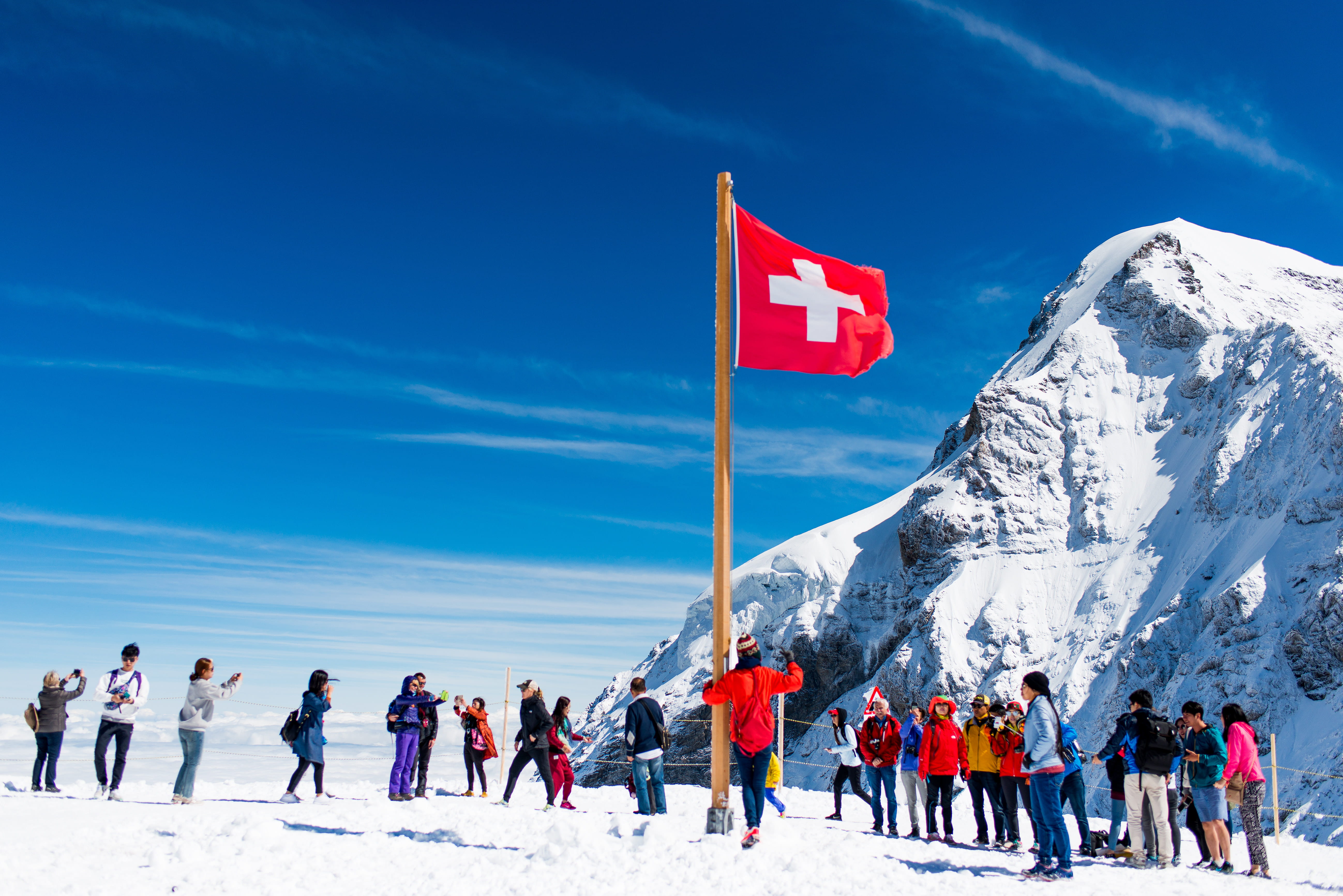 warm clothing, snow, scenics - nature, mountain, leisure activity, mountains, patriotism, lauterbrunnen, day, top of europe, winter, sky, outdoors, group of people, HD Wallpaper