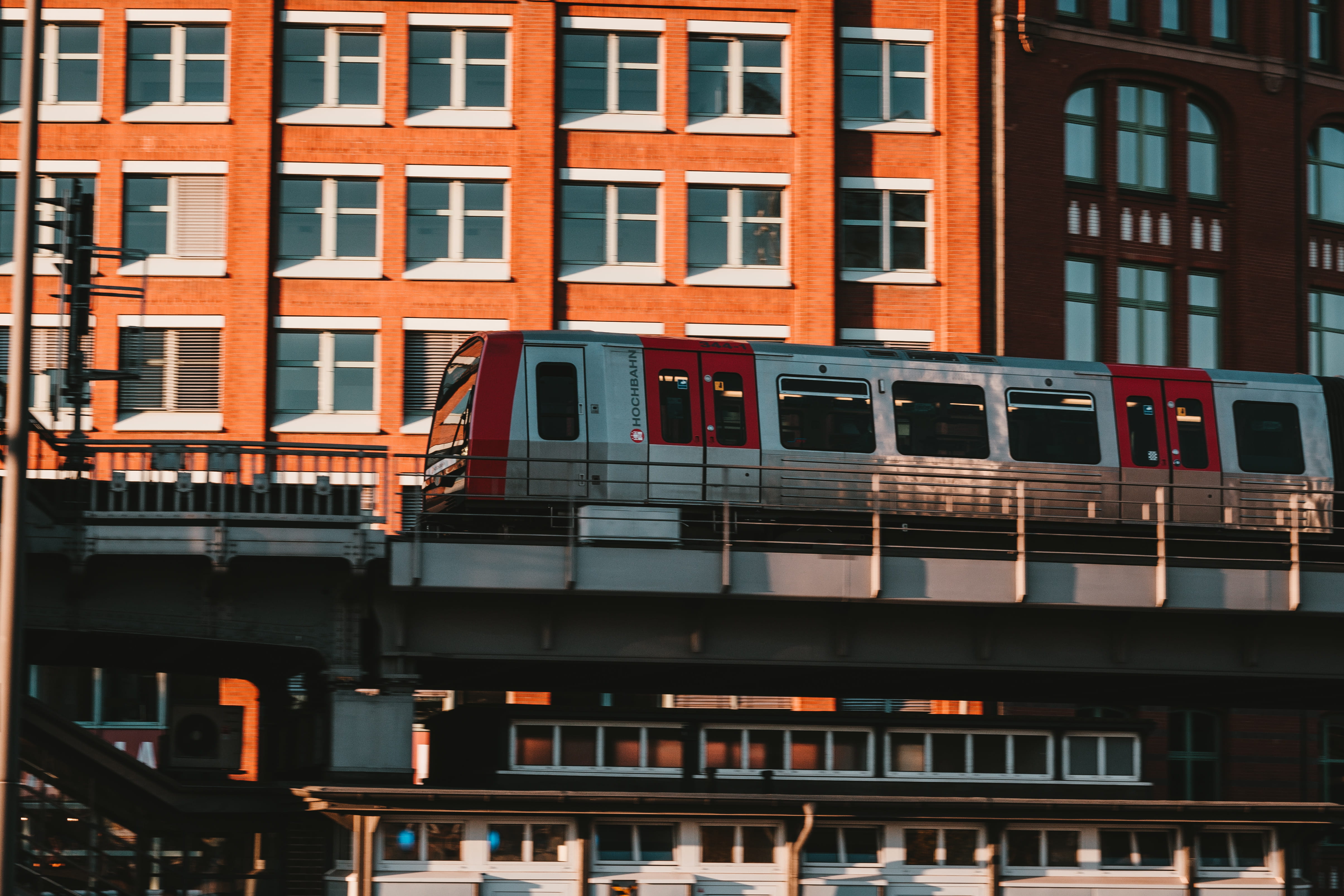 train, sunlight, building exterior, building, red, facade, no people, apartment, home, vehicle, locomotive, business, built structure, road, train - vehicle, HD Wallpaper