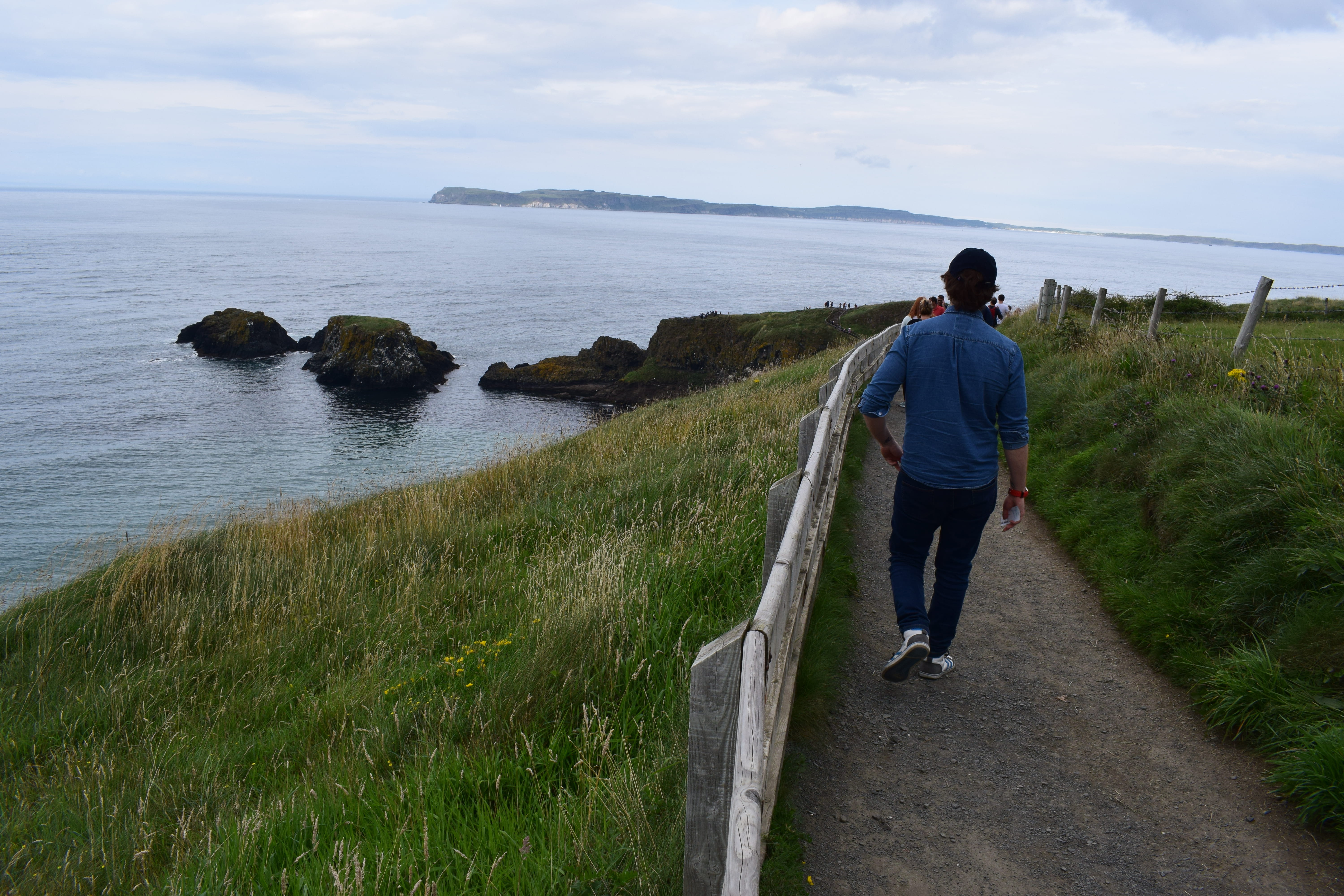 united kingdom, outdoors, casual clothing, men, real people, sky, one person, hiking, plant, sea, looking at view, lifestyles, carrick-a-rede rope bridge, HD Wallpaper
