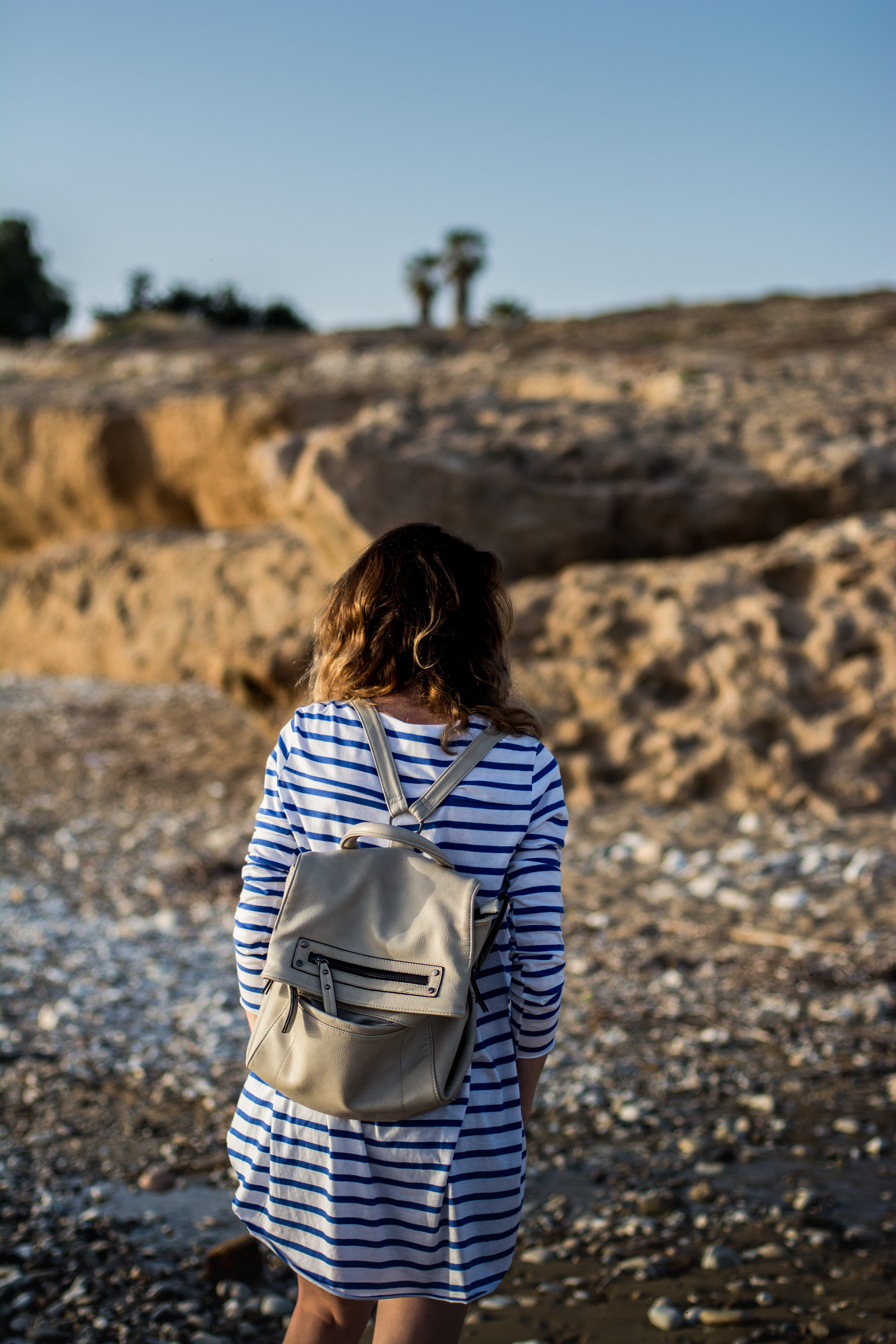 seaside, land, paphos, hair, focus on foreground, nature, one person, three quarter length, beach, tombs of the kings, adult, hairstyle, woman, environment, Phone HD Wallpaper