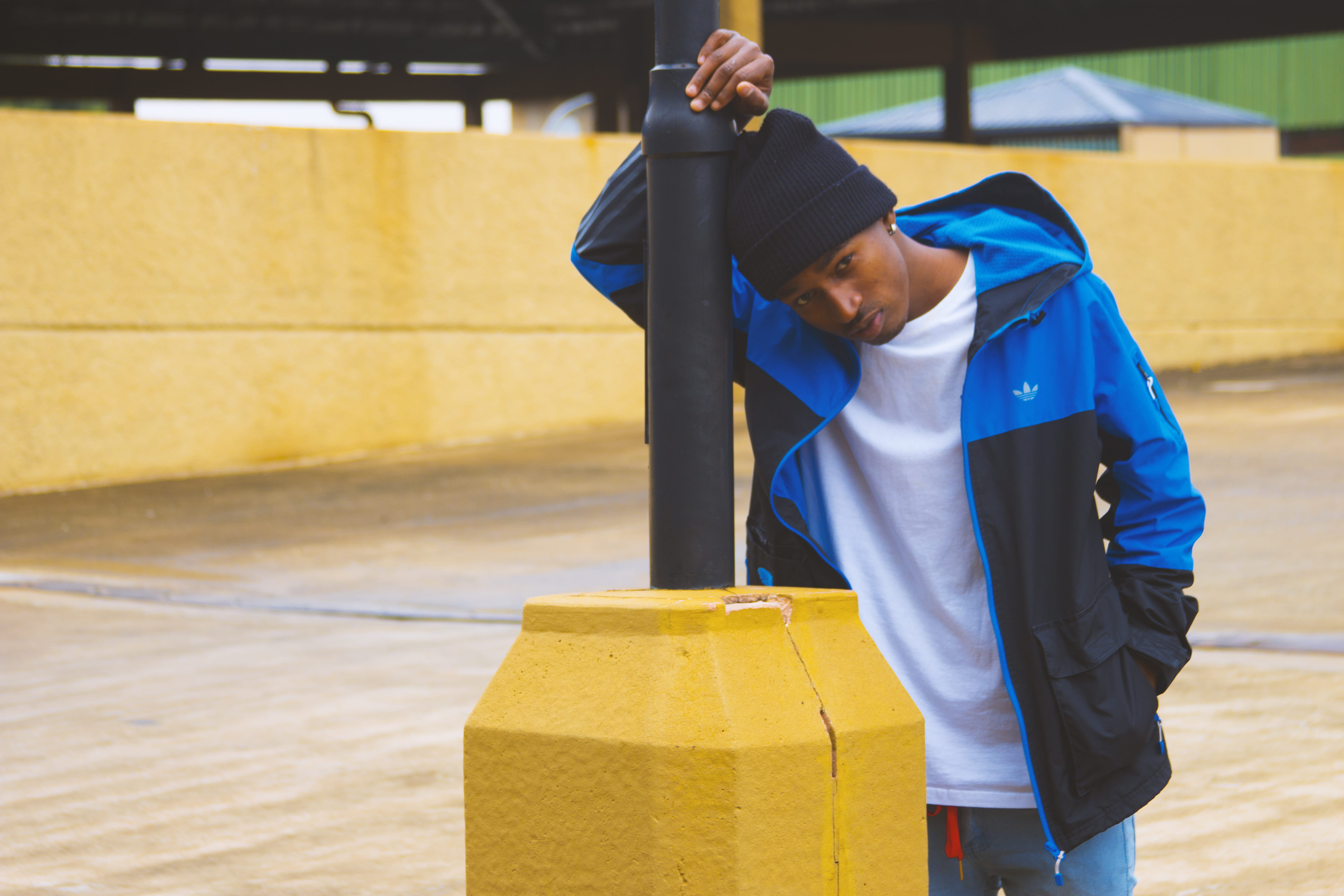 5K, female, leaning, outdoors, black, shelter, countryside, long sleeve, yellow, building, real people, focus on foreground, water, three quarter length, HD Wallpaper