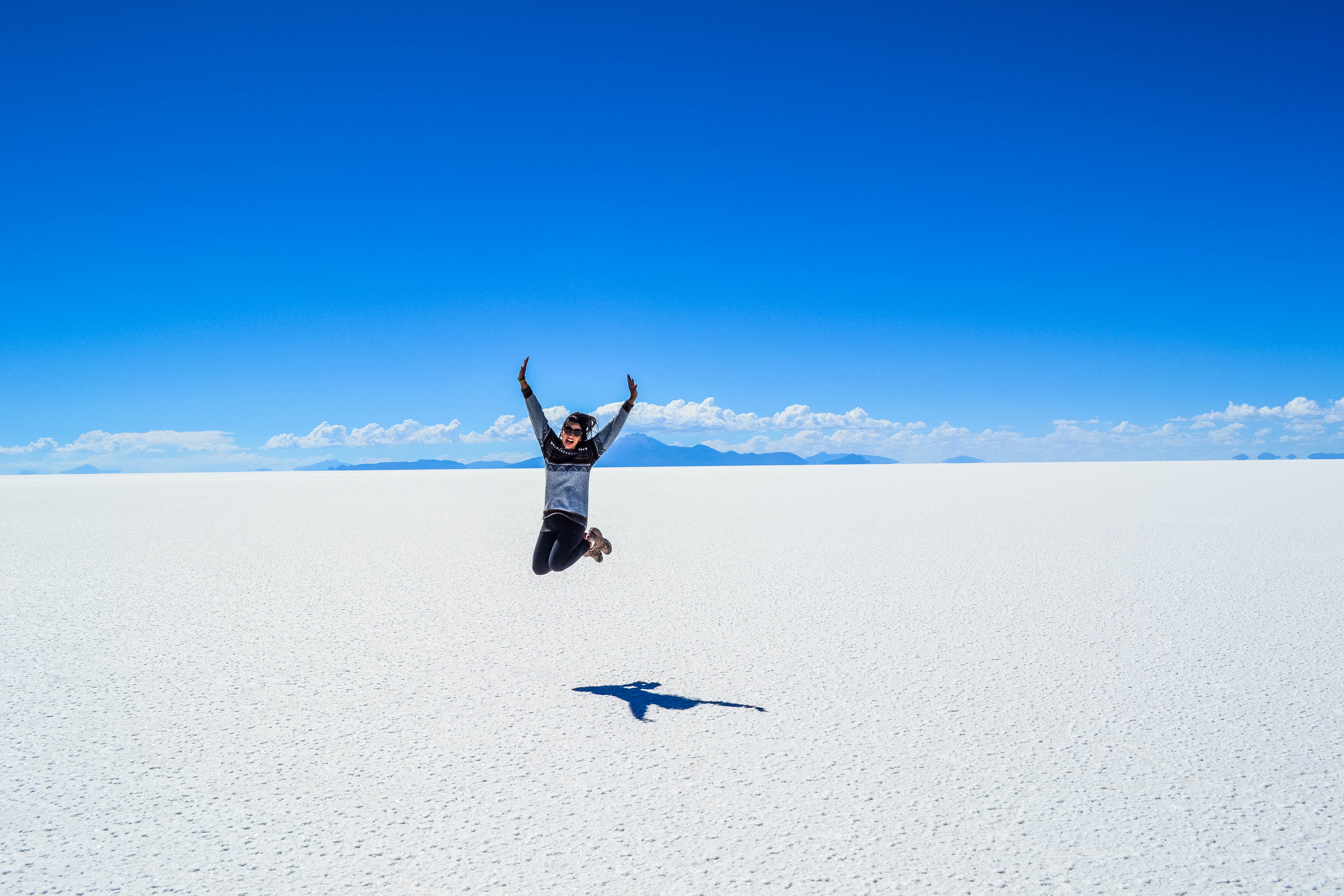 human arm, 4K, shot, freedom, body part, woman, land, day, leisure activity, trip, sky, blue, holiday, salt flat, arms raised, tranquil scene, jumping, HD Wallpaper