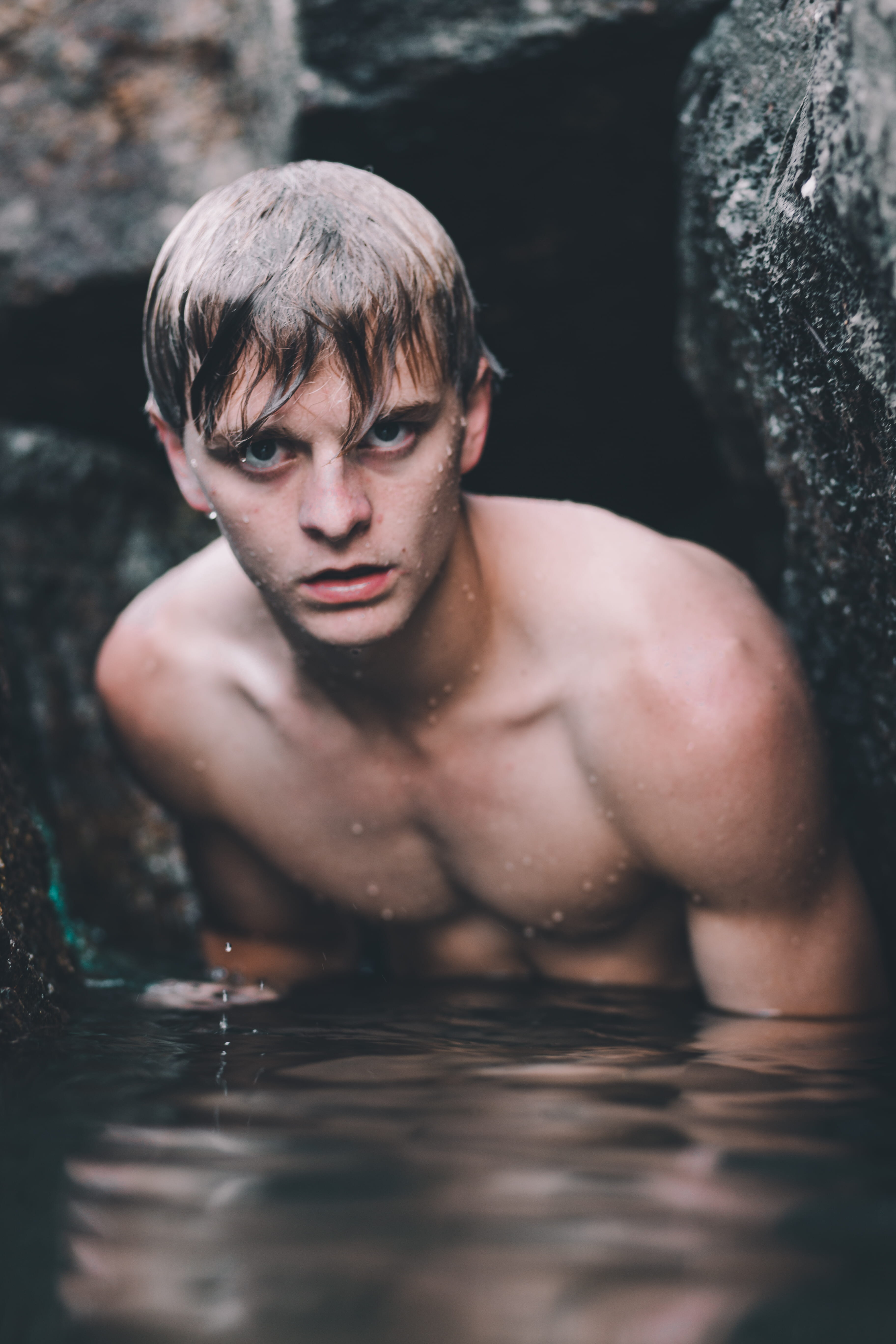 gaze, closeup, rock, leisure activity, lifestyles, selective focus, water, looking at camera, person, portrait, serious, taking, real people, men, droplet, Phone HD Wallpaper