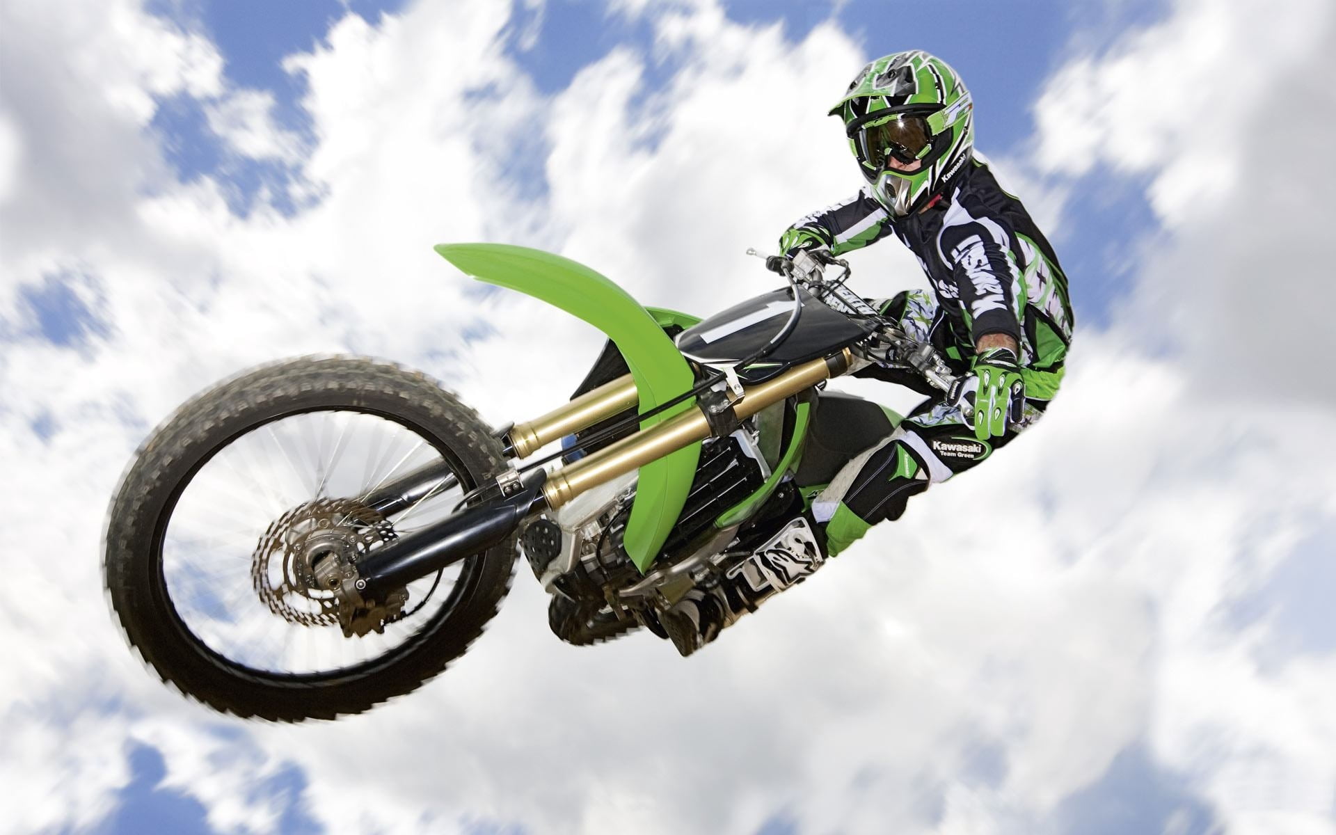 fun, outdoors, motorcycle, protective Sportswear, exhilaration, motorcycle Racing, stunt, sports Race, nature, action, mid-air, green, cloud - sky, extreme, HD Wallpaper